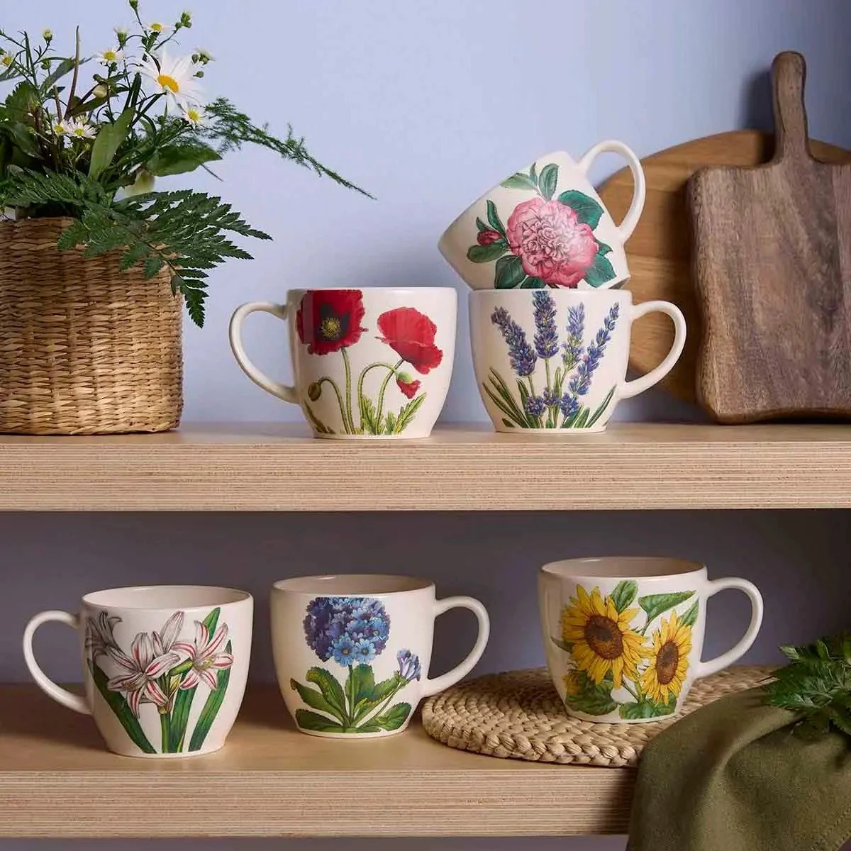 Floral mug set sitting on shelf amongst other items.