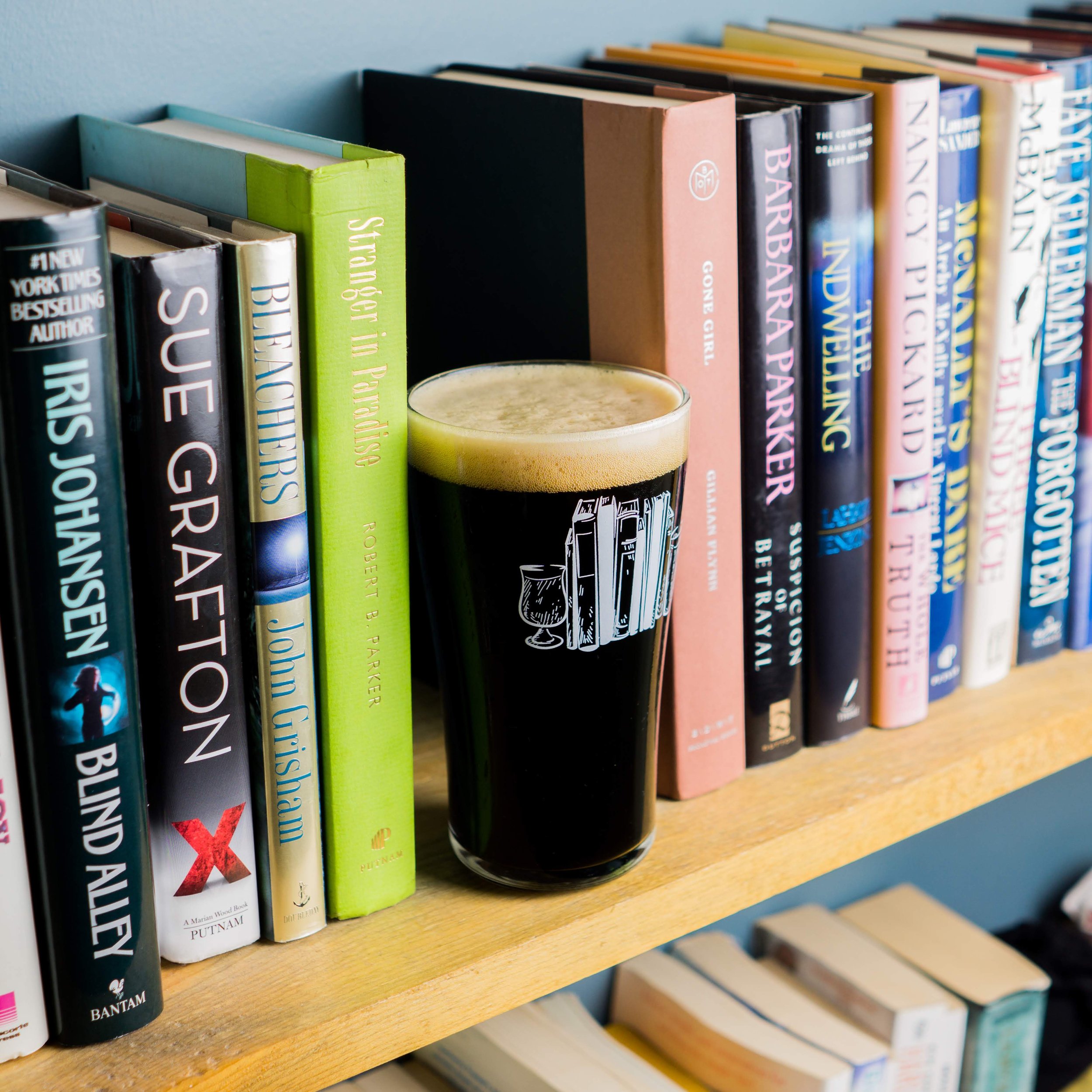 Beer on shelf with books