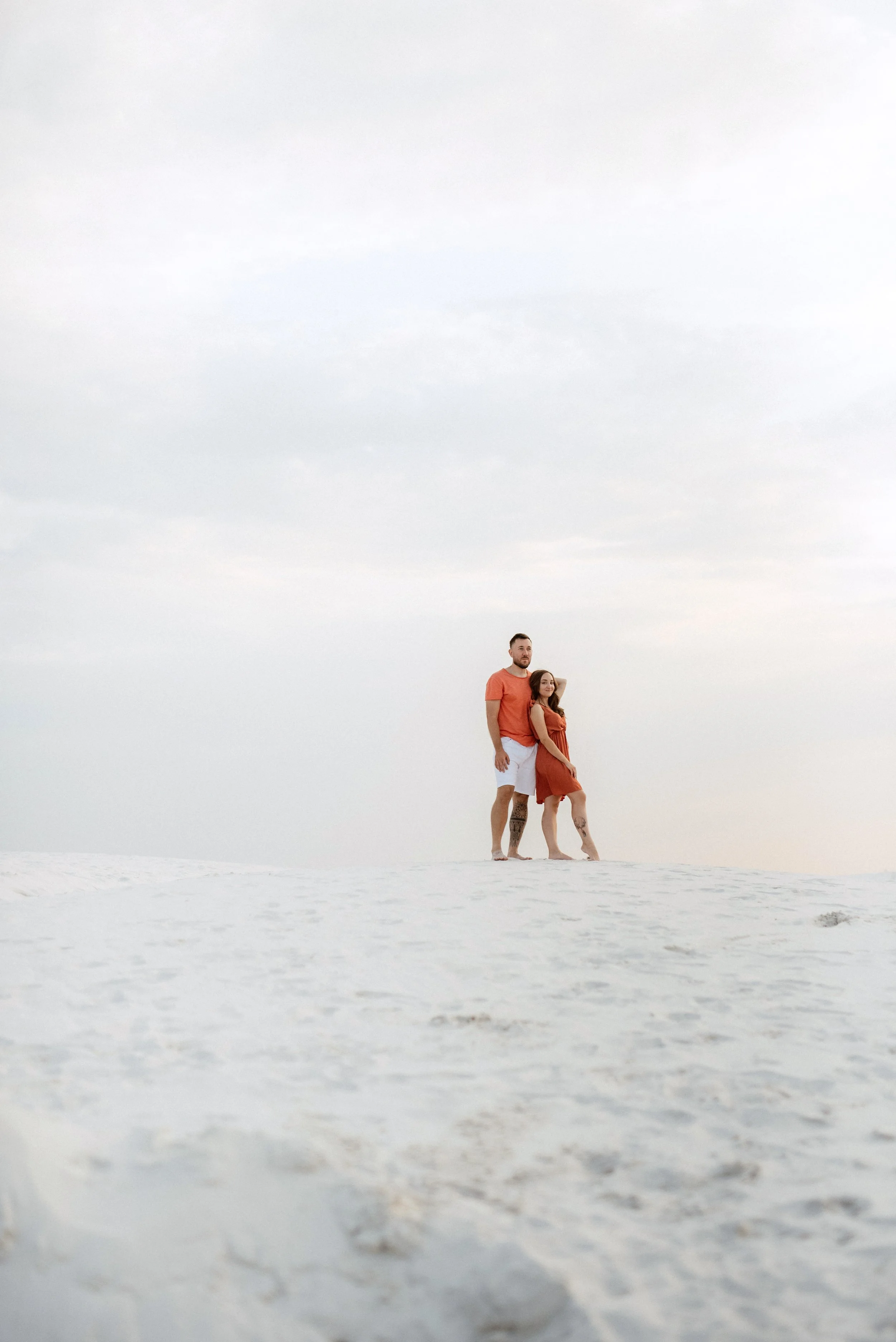Two people standing on a beach