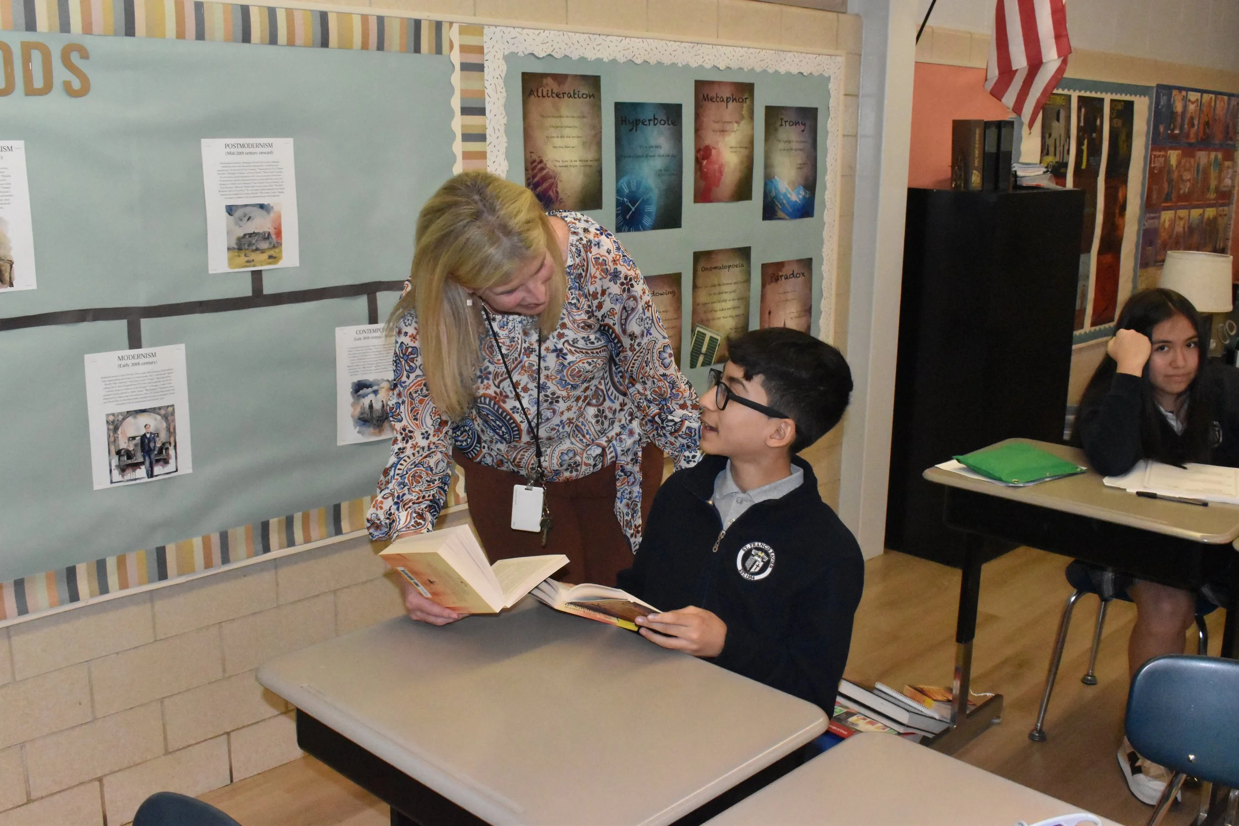 A middle school literature teacher at St. Francis Xavier Catholic School in Birmingham, Alabama, speaks to a student about great books