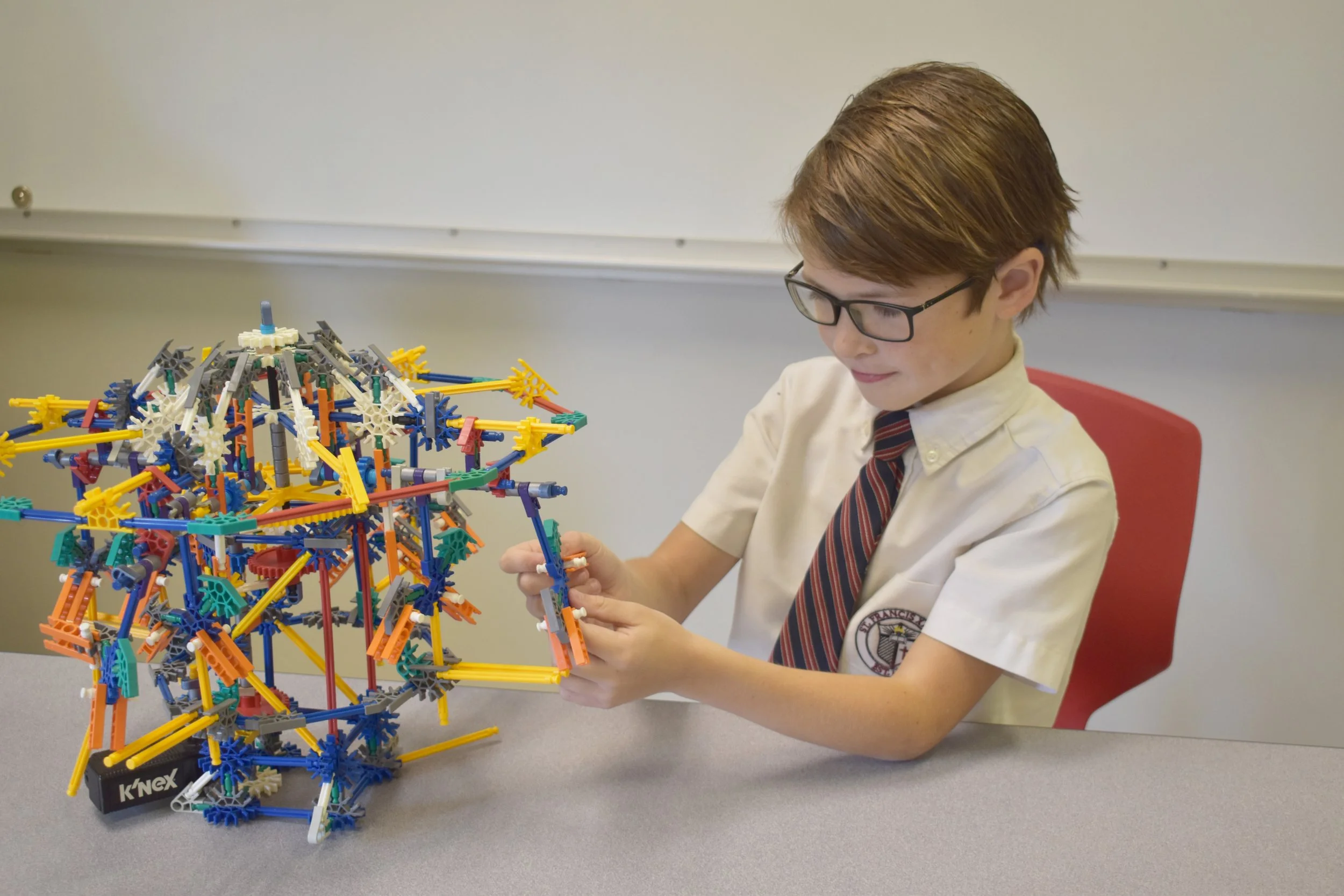 Elementary Student at St. Francis Xavier Catholic School in Birmingham, Alabama, puts the finishing touches on a project in his STEAM special