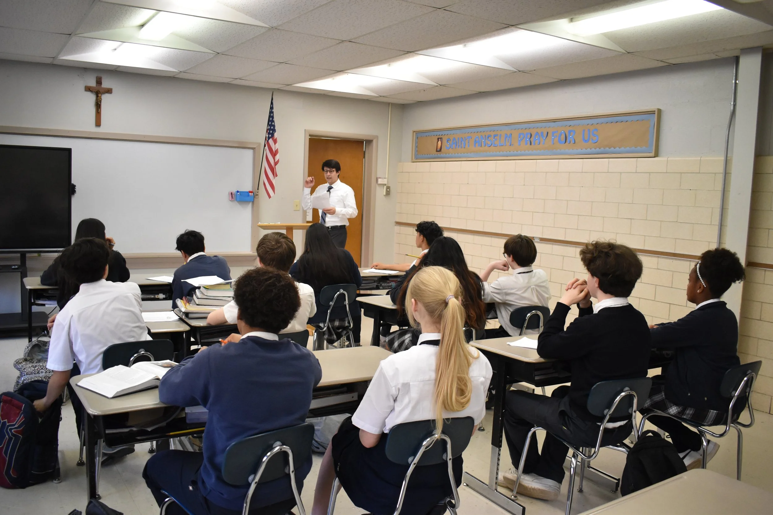 A middle school religion teacher at St. Francis Xavier Catholic School in Birmingham, Alabama instructs a class on the Bible