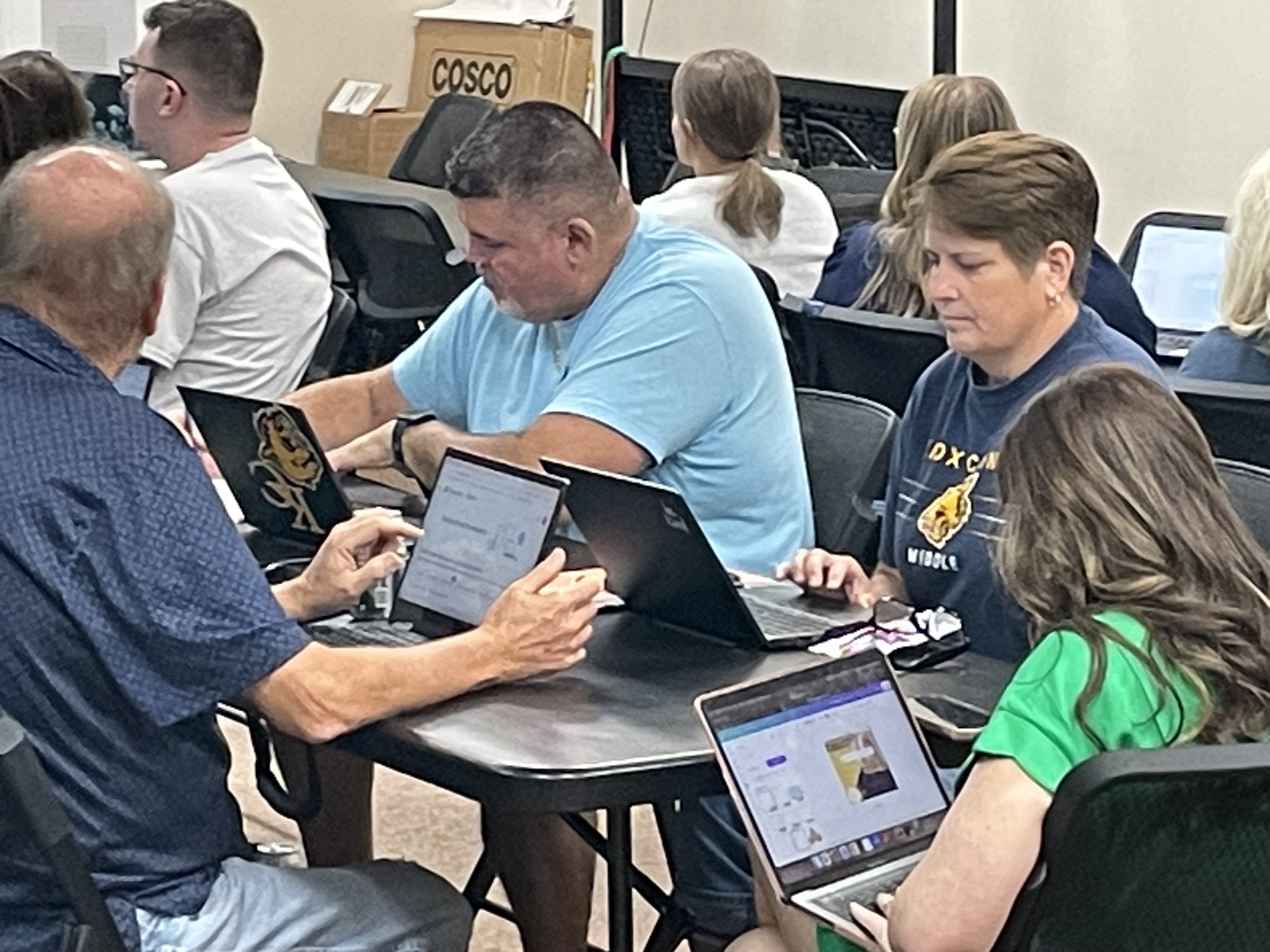 Teachers in professional development session on computers
