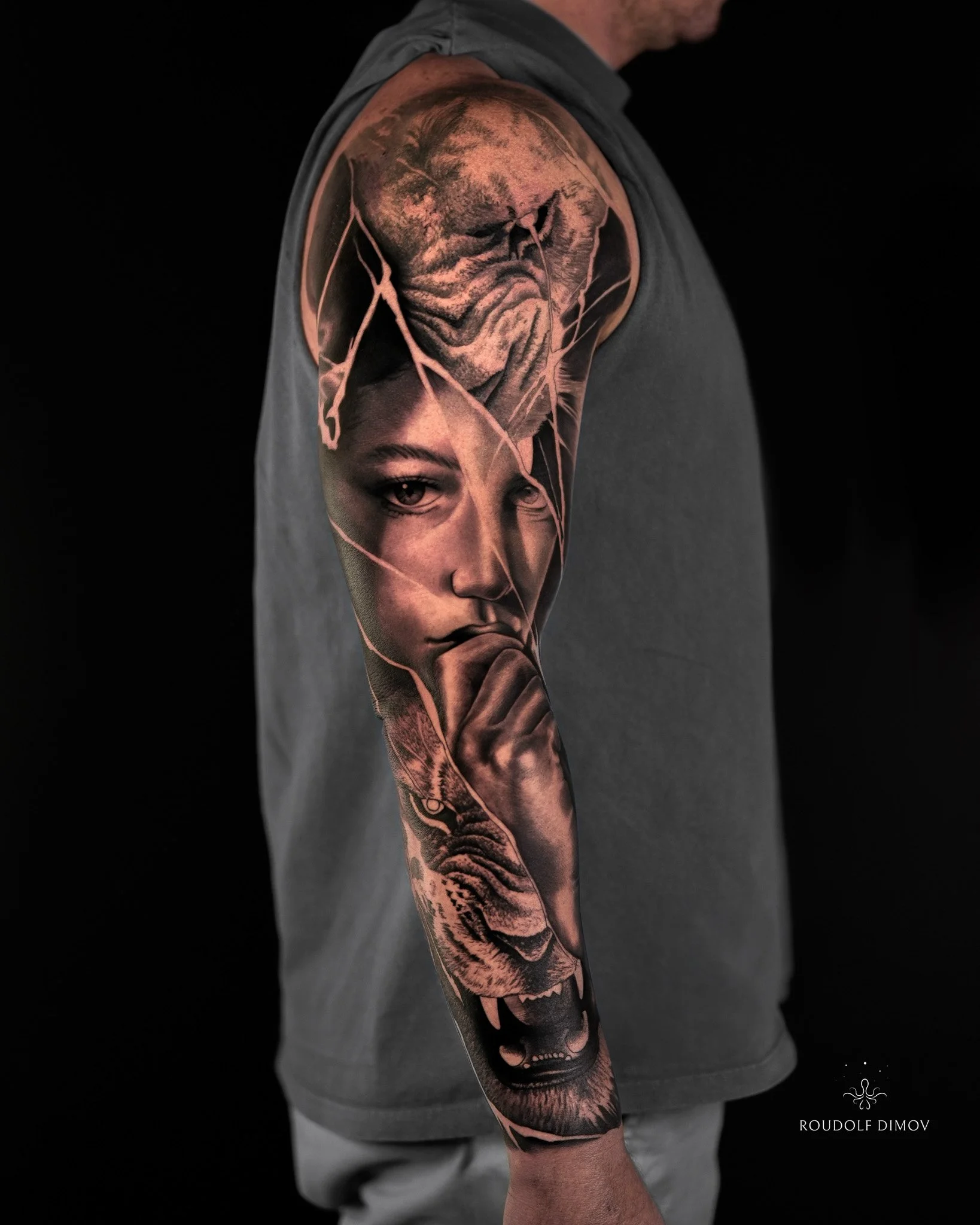 Broken portrait and tiger full sleeve tattoo in black and grey realism, featuring detailed facial textures, dynamic composition, and high-contrast wildlife elements. Tattoo artist Roudolf Dimov, London.