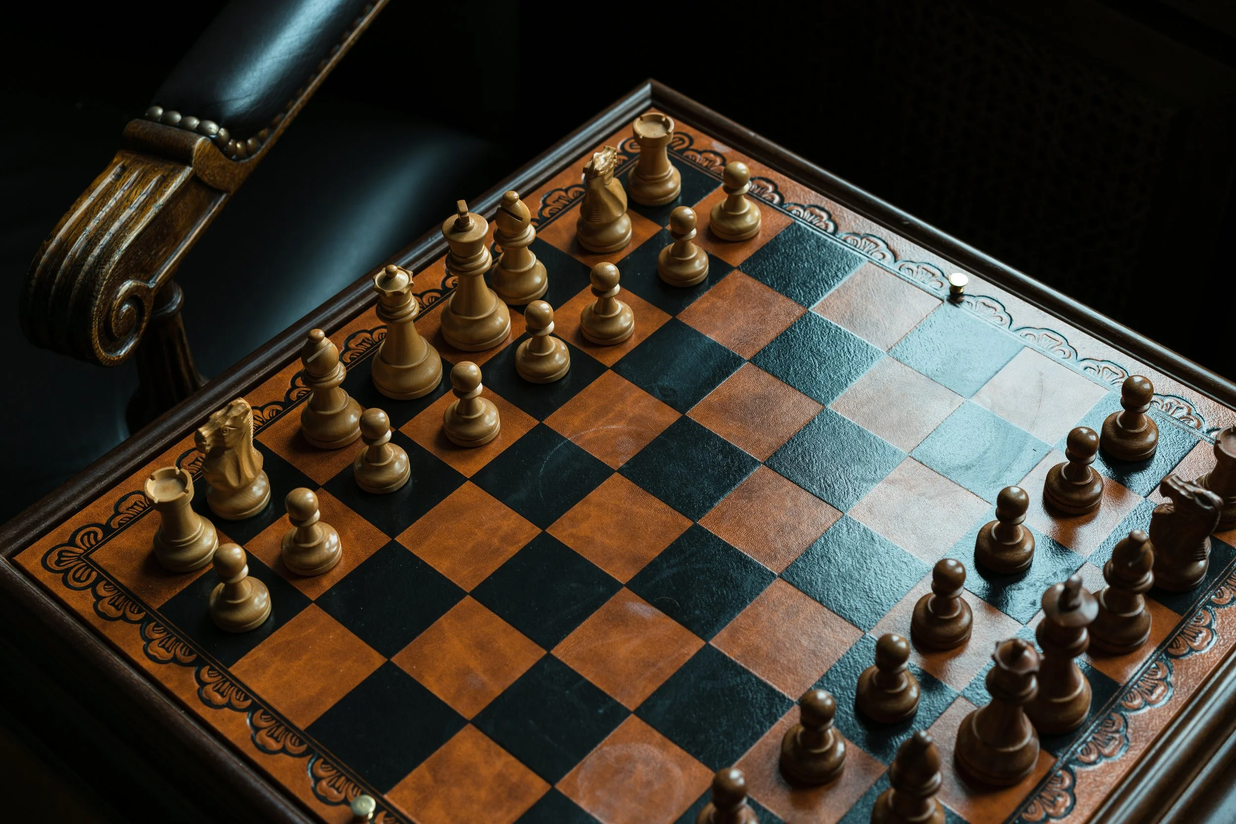A picture of a chess board fully set up against a dark background