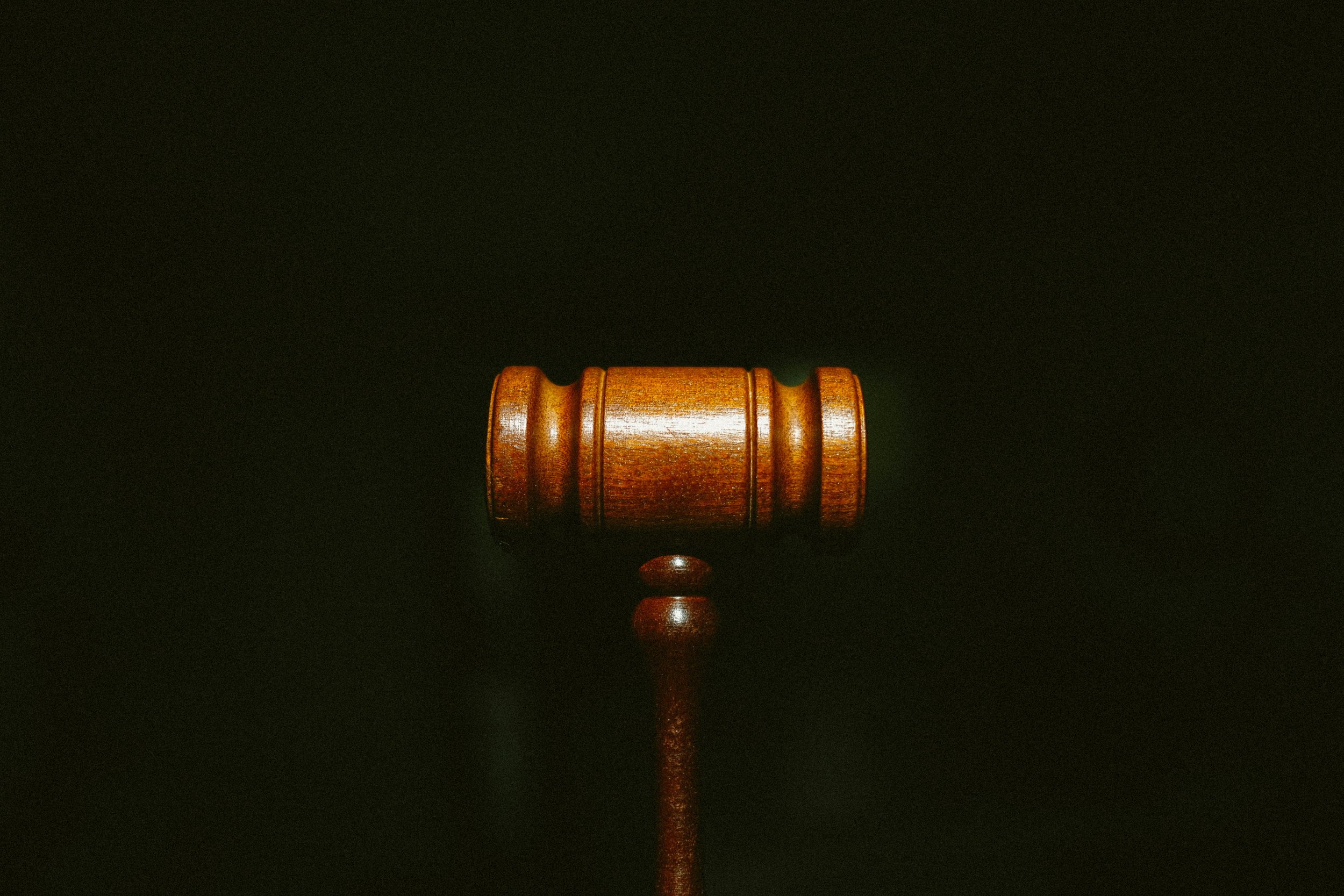 Picture of a judge's gavel against a black background