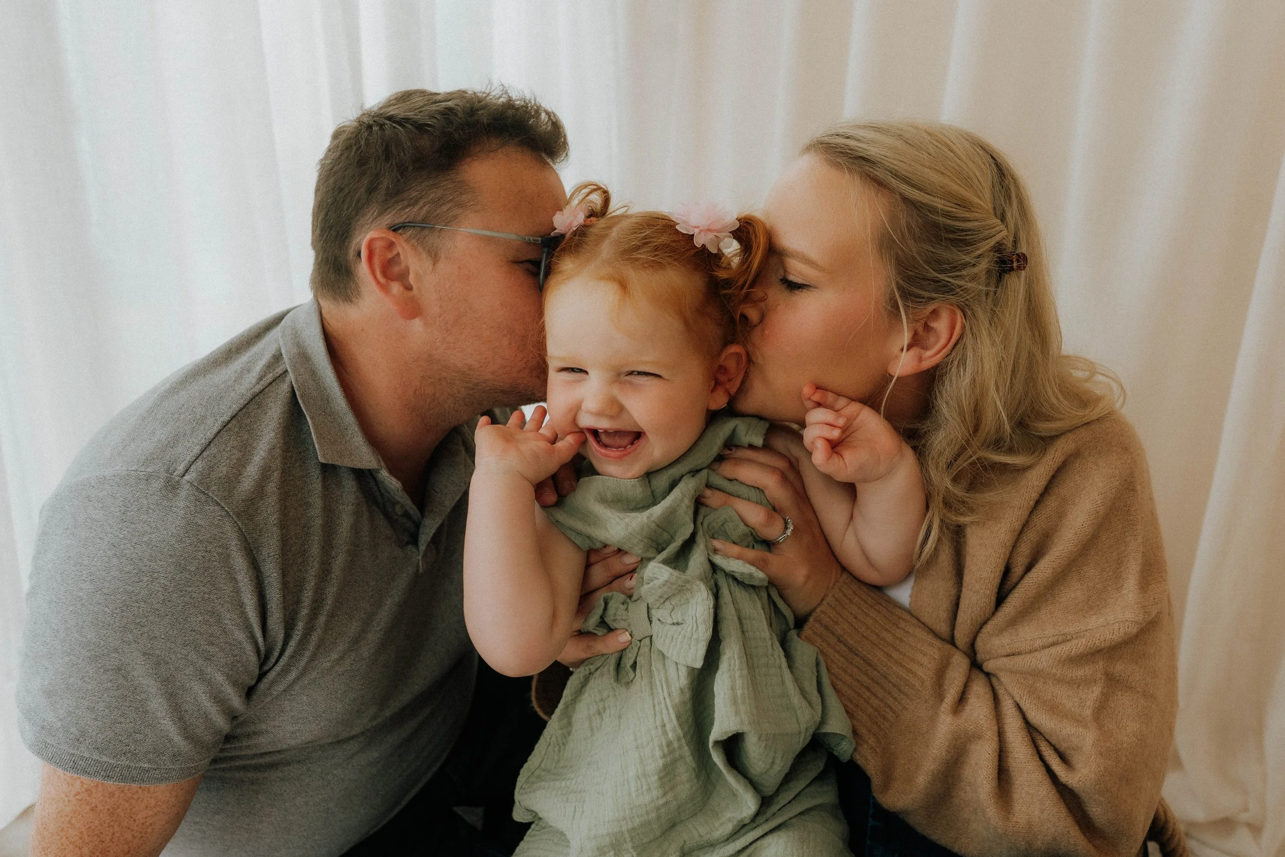 Image of a family of three in Didsbury Family Photography Studio.
