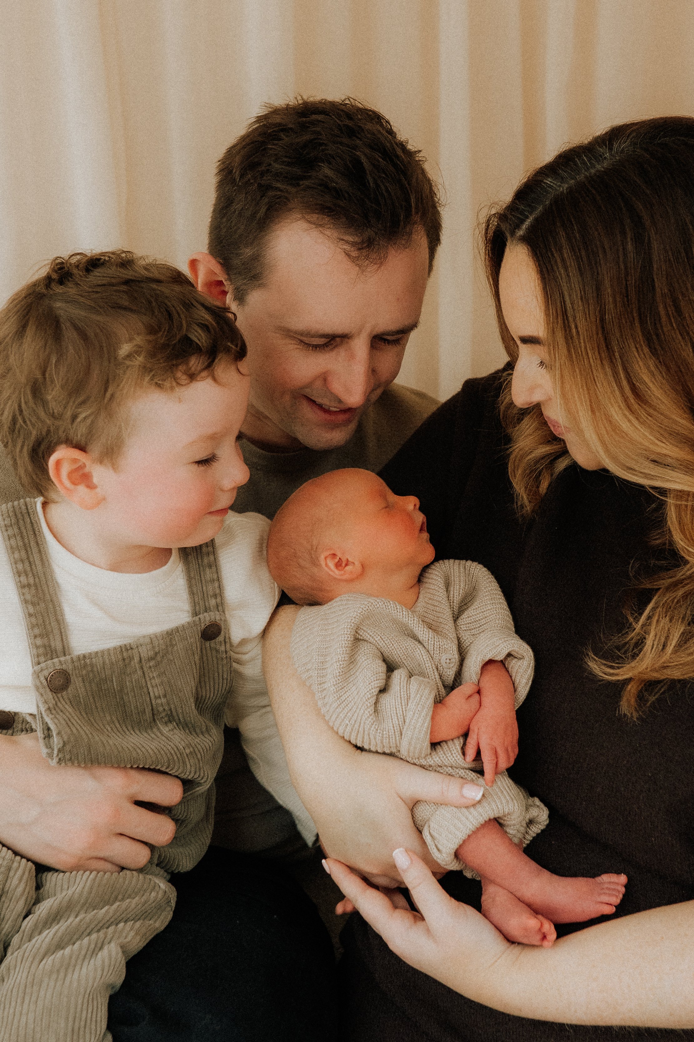 A close up photo of a family of four on their newborn studio shoot in Didsbury Manchester