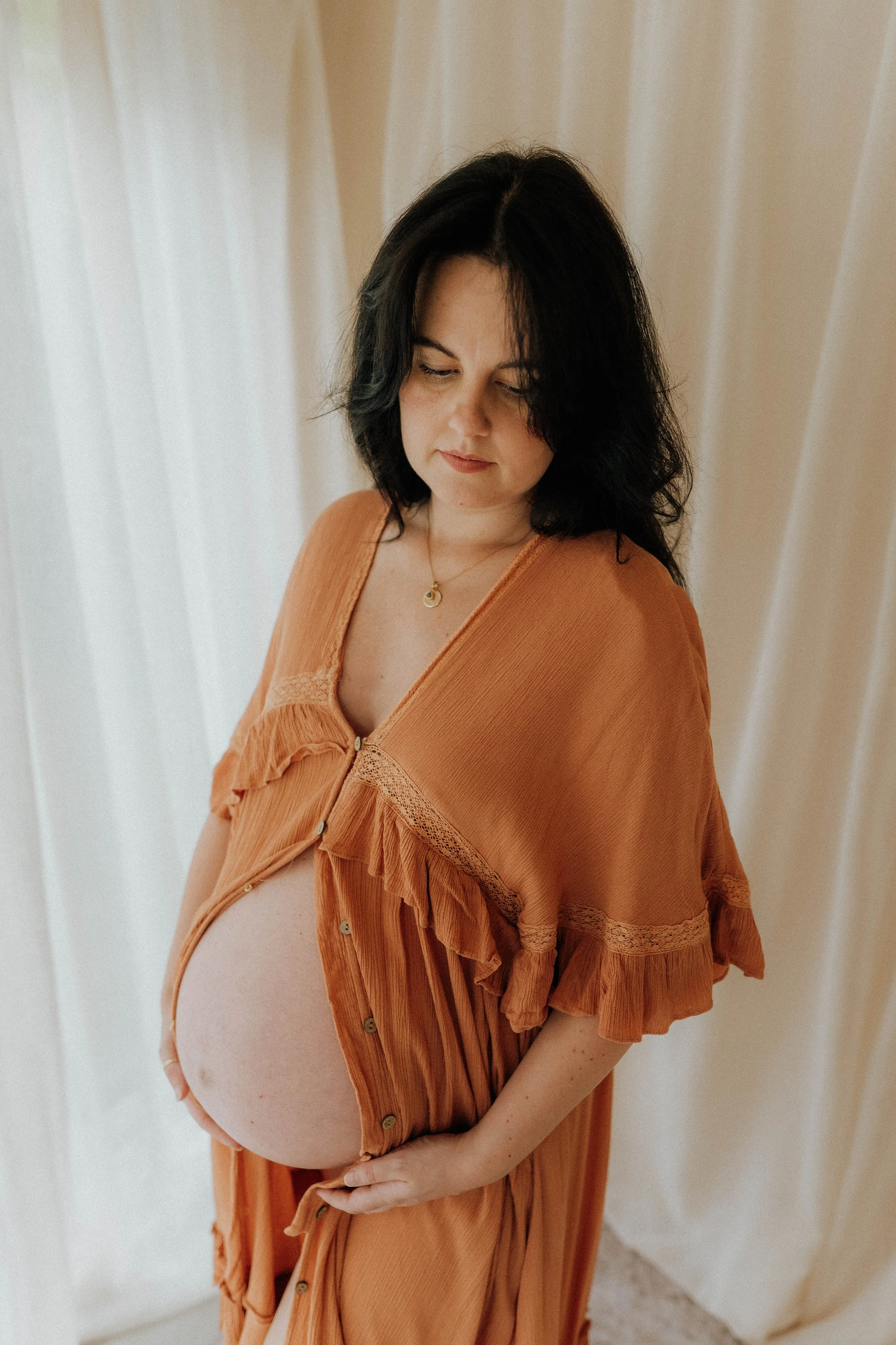 Image of a woman on her maternity shoot at Didsbury Photo Studio