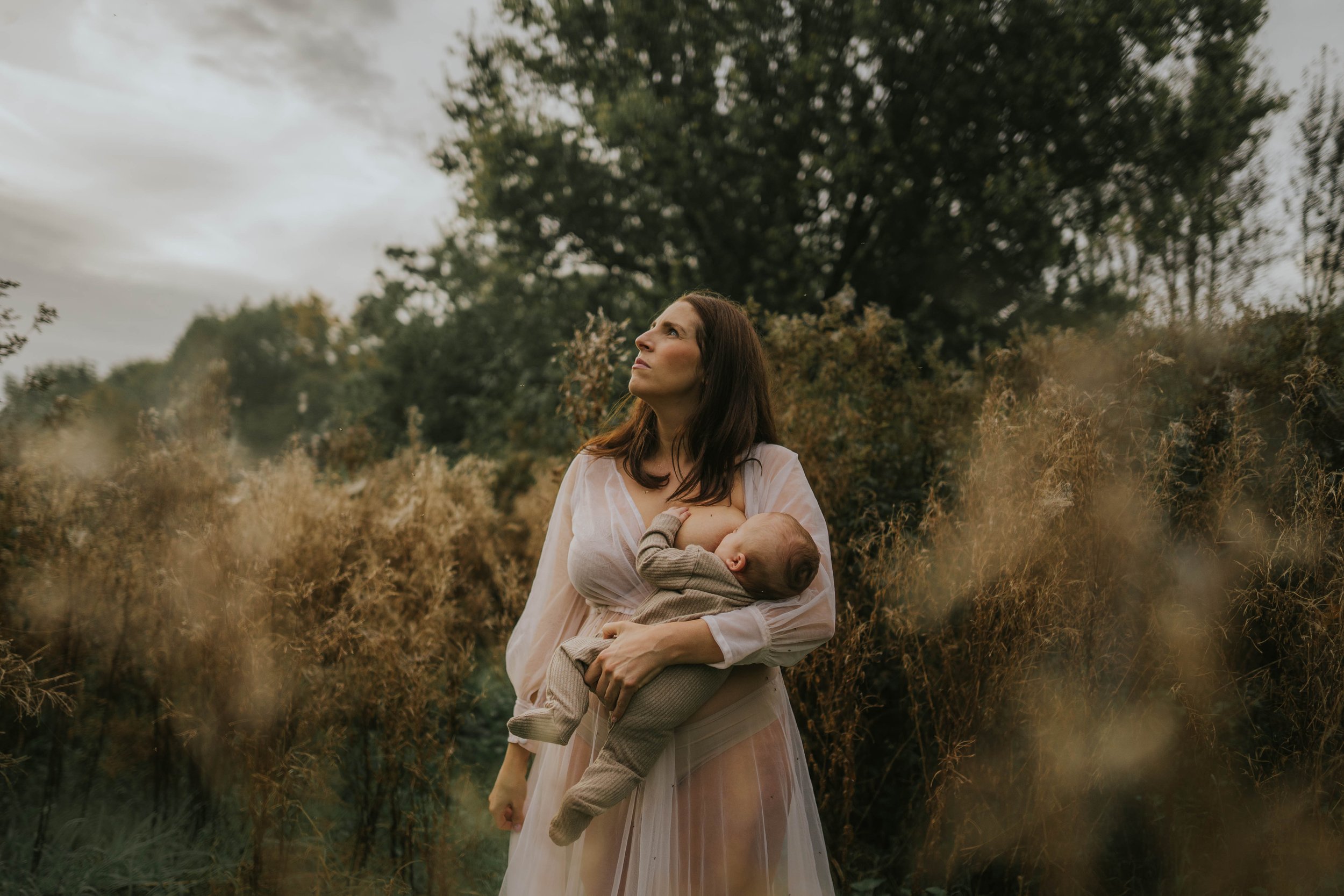 image of a mother nursing her child on her motherhood shoot in Didsbury Manchester