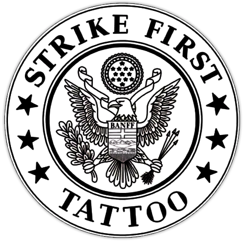 A circular black and white logo with the text "Strike First Tattoo" around the border. In the center, there is an eagle with outstretched wings holding a banner labeled "BANFF" and a bundle of arrows and an olive branch.