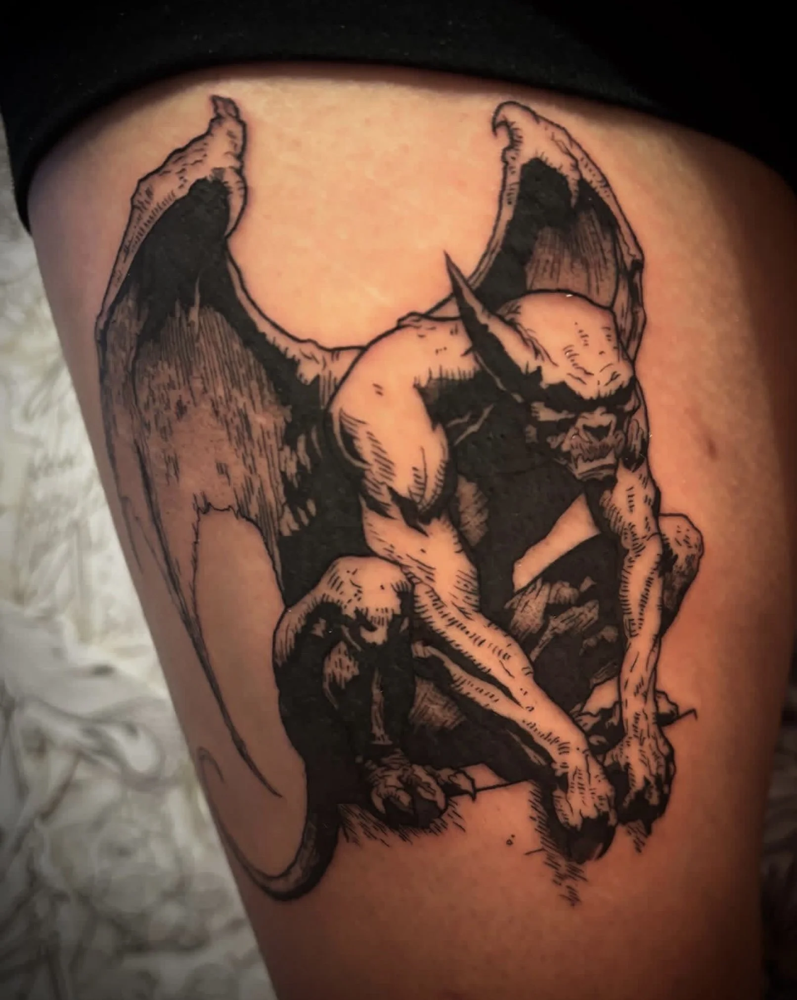 Black and gray tattoo of a muscular dog with a suit, sitting and staring forward.