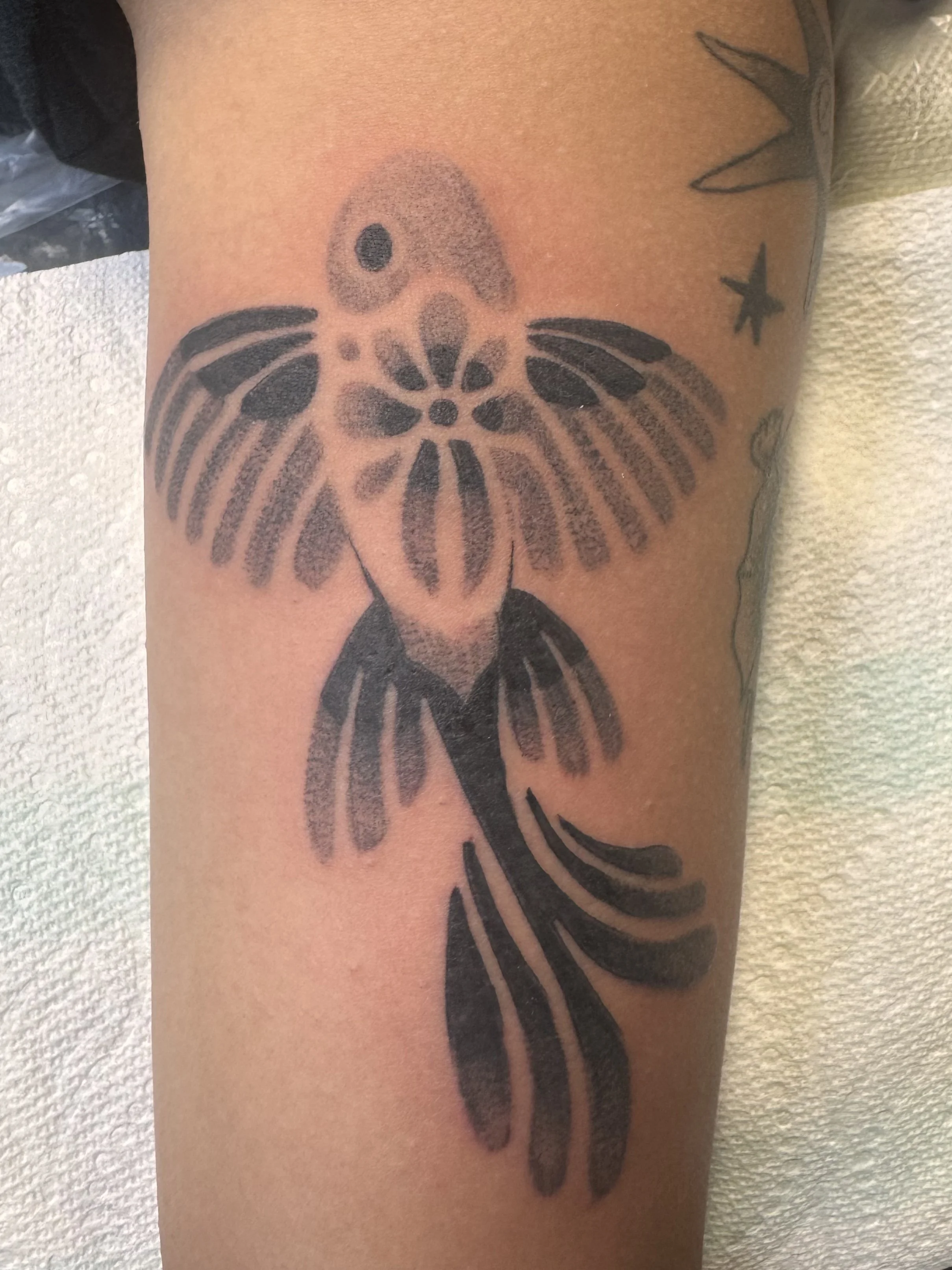 Tattoo of a butterfly with a skull face on a person's skin.