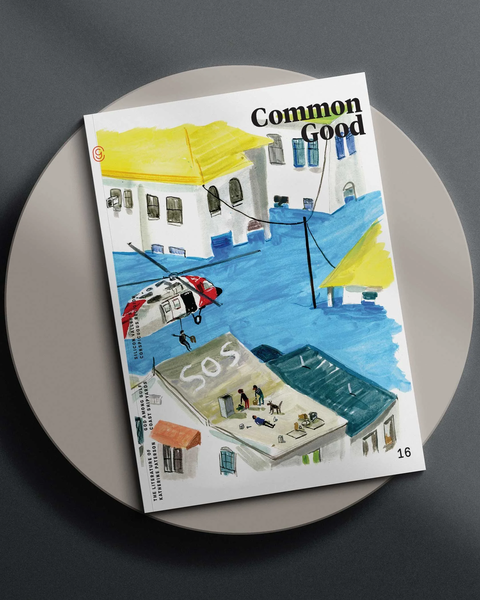 Magazine cover titled "Common Good" featuring an illustration of flooded buildings with yellow roofs, a helicopter in the sky, and an SOS sign on a rooftop with people and a dog. Issue number 16 is visible.