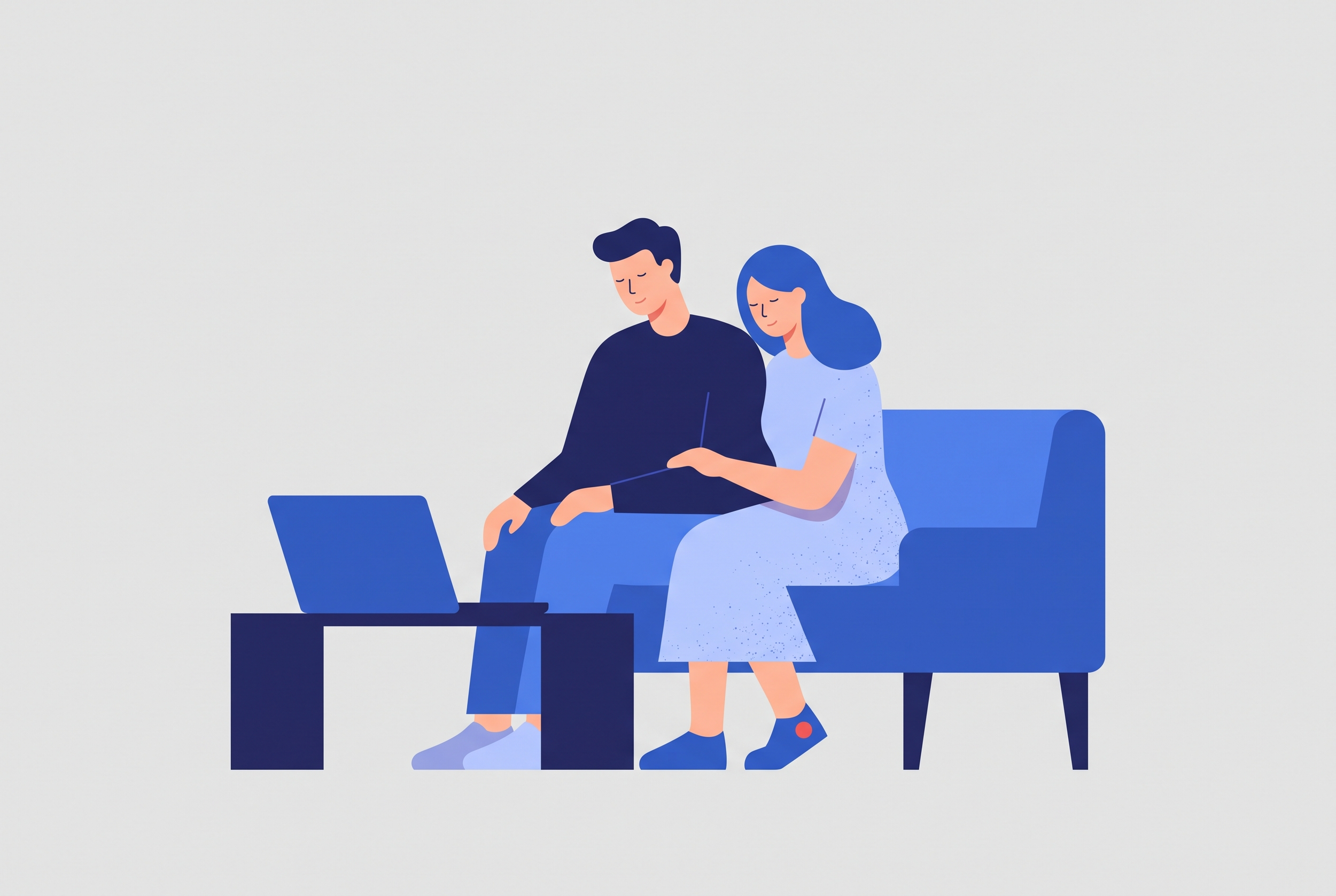 A couple sitting together at a laptop during an online couples therapy session