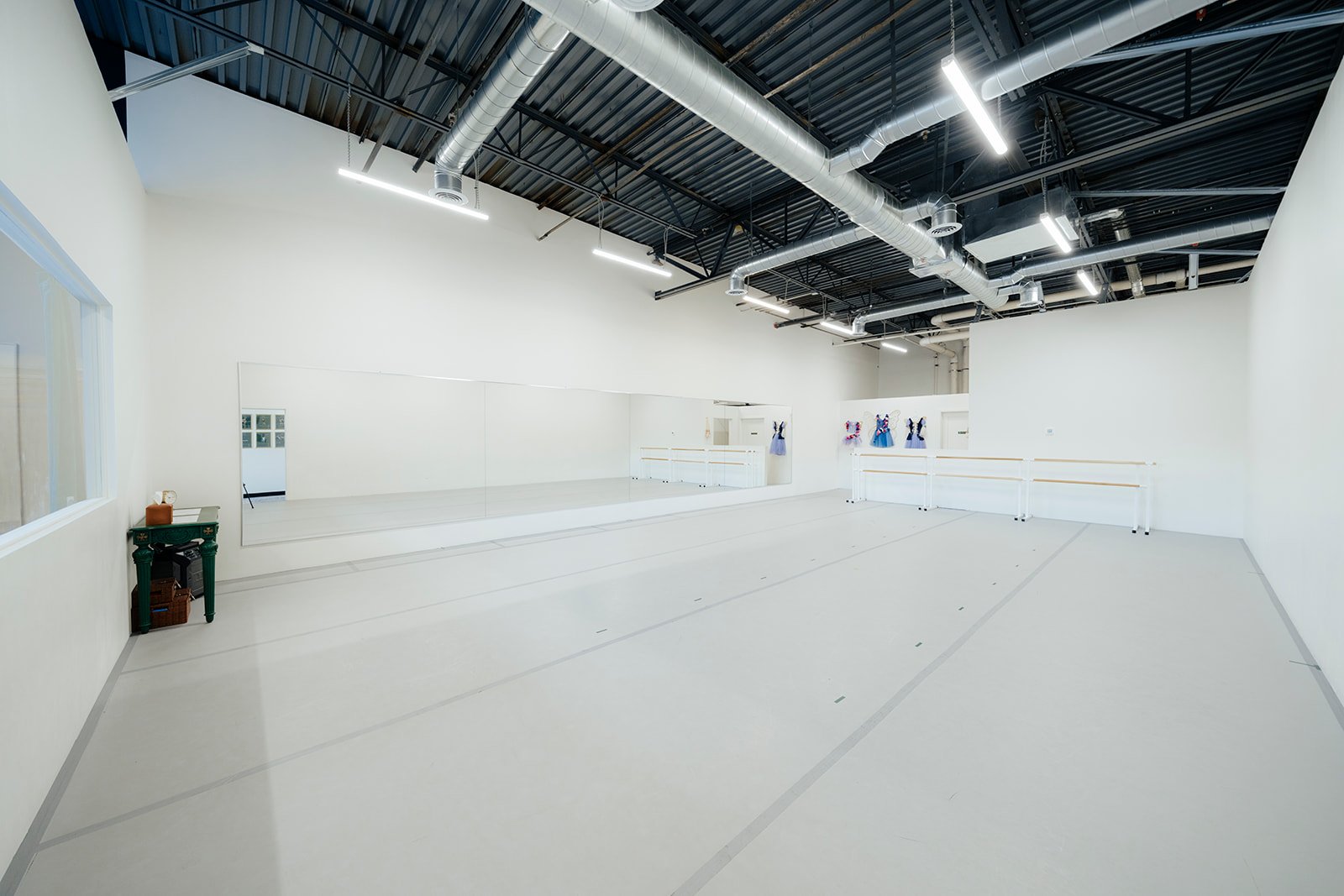 Open dance studio with mirrored walls and dance bars