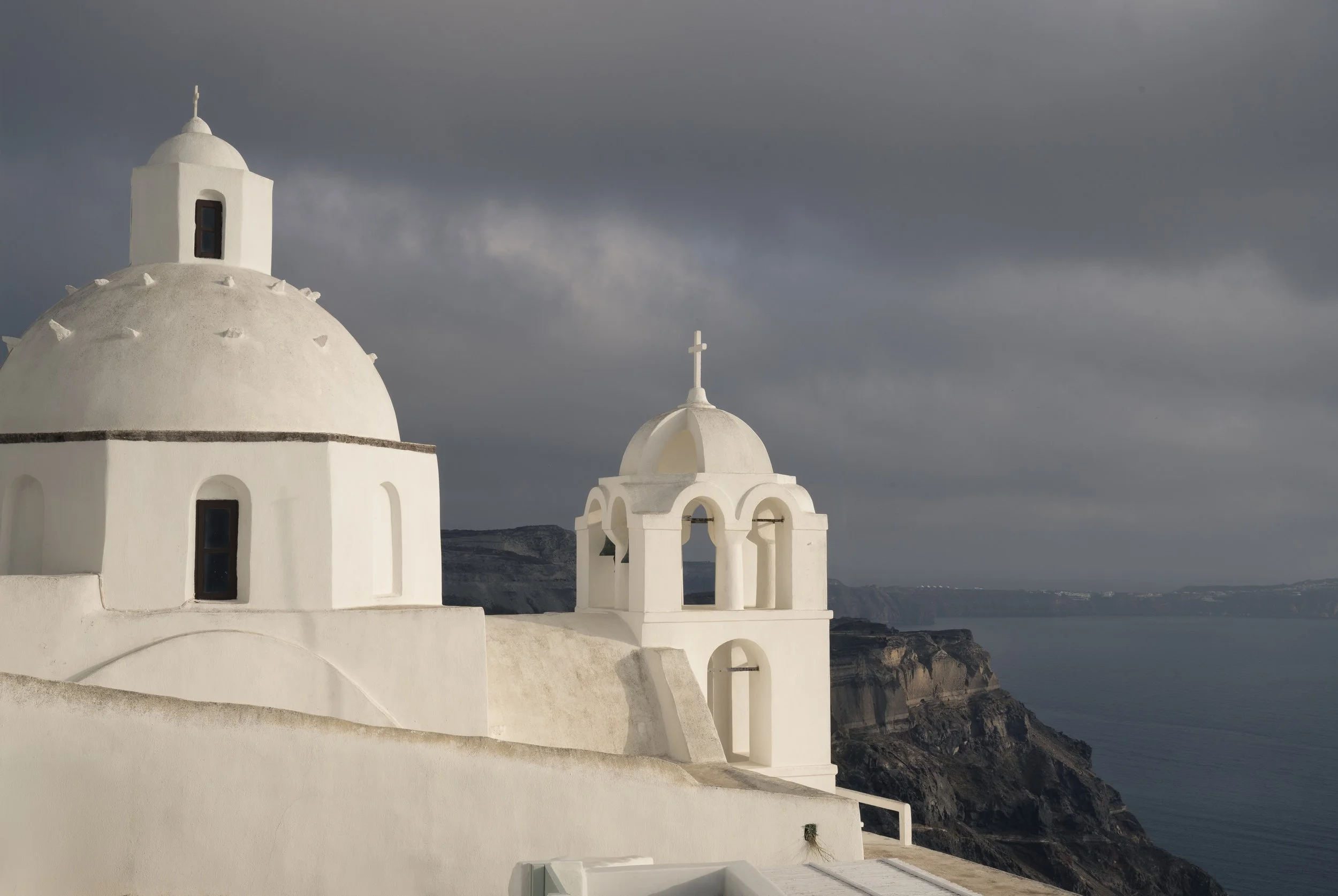 Fog rolling in over Santorini in the late afternoon casts an eerie light - Greece