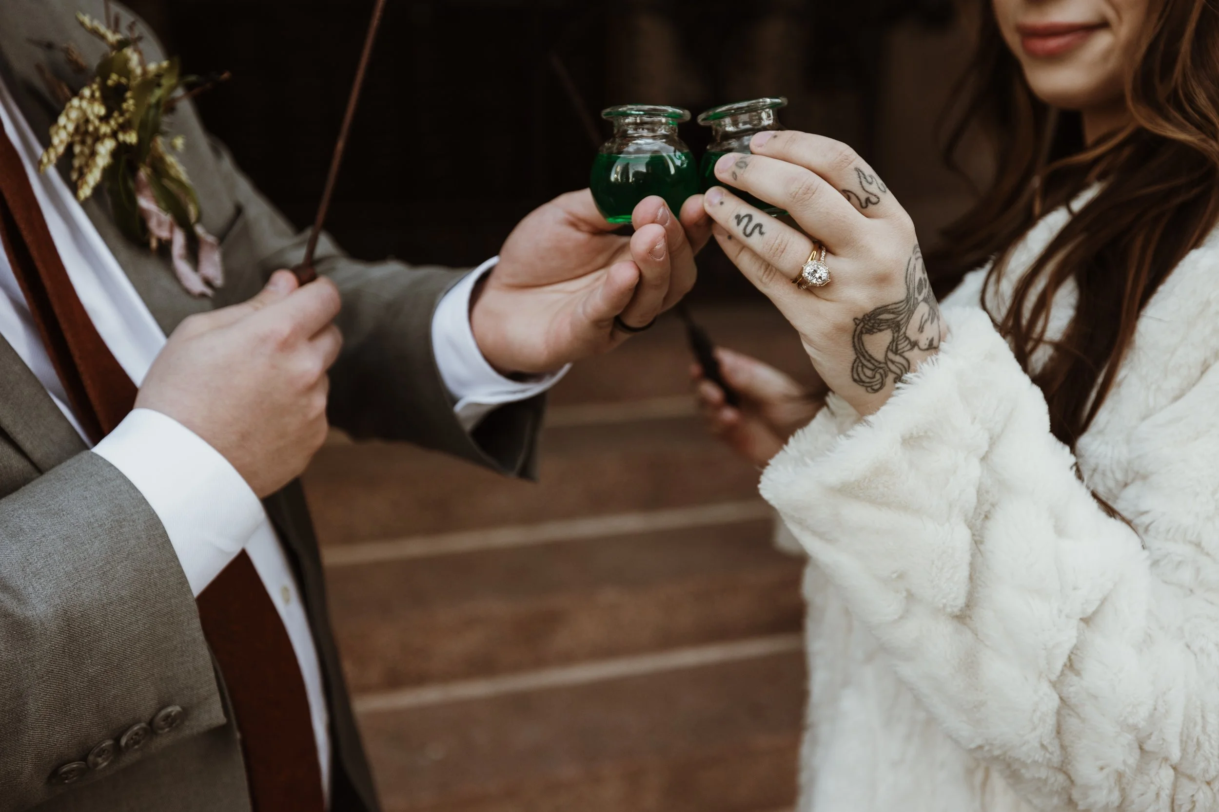 bride and groom cheers with potion bottles
