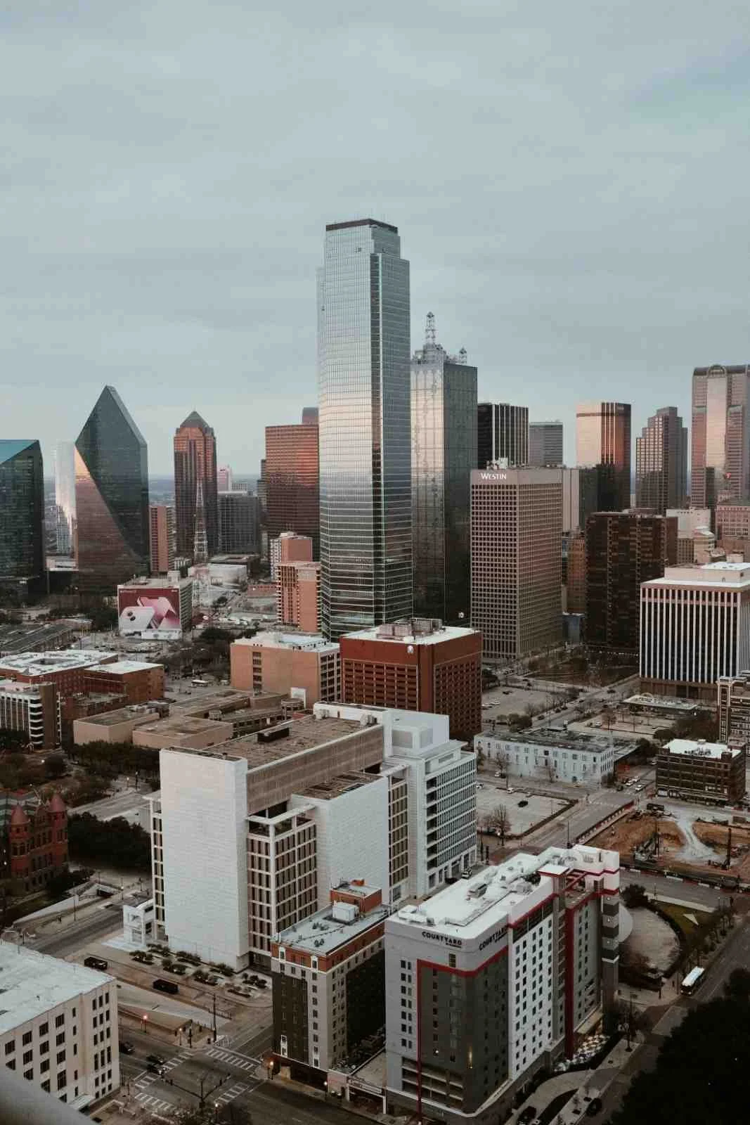 Aerial view of downtown Dallas skyline with modern skyscrapers, symbolizing high-performing professionals seeking focused healing, emotional relief, and accelerated progress through EMDR intensive therapy in Dallas.