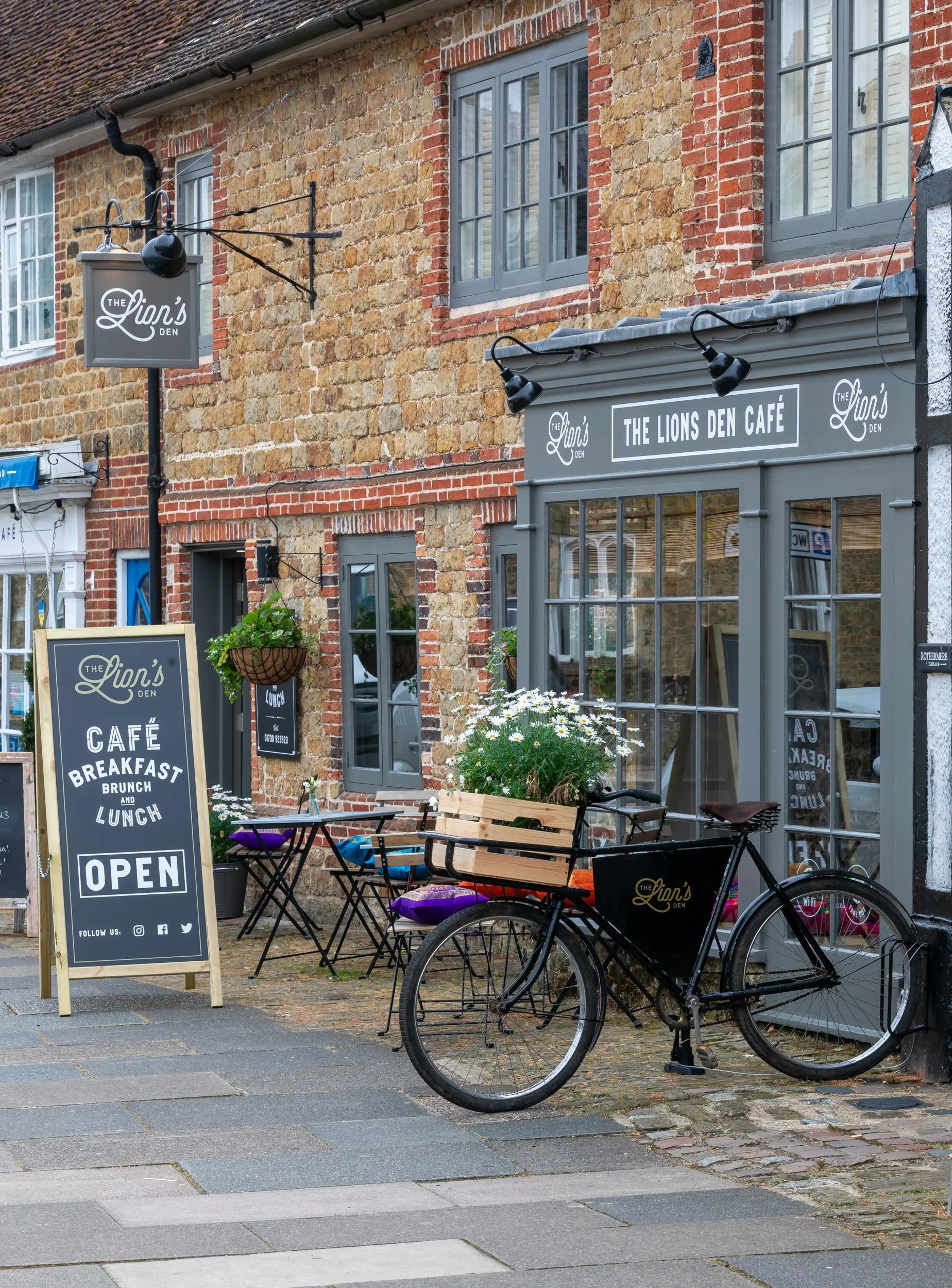 Café exterior featuring signature delivery bicycle – The Lion's Den Midhurst – Hospitality Venue Photography by Sequoia Studios