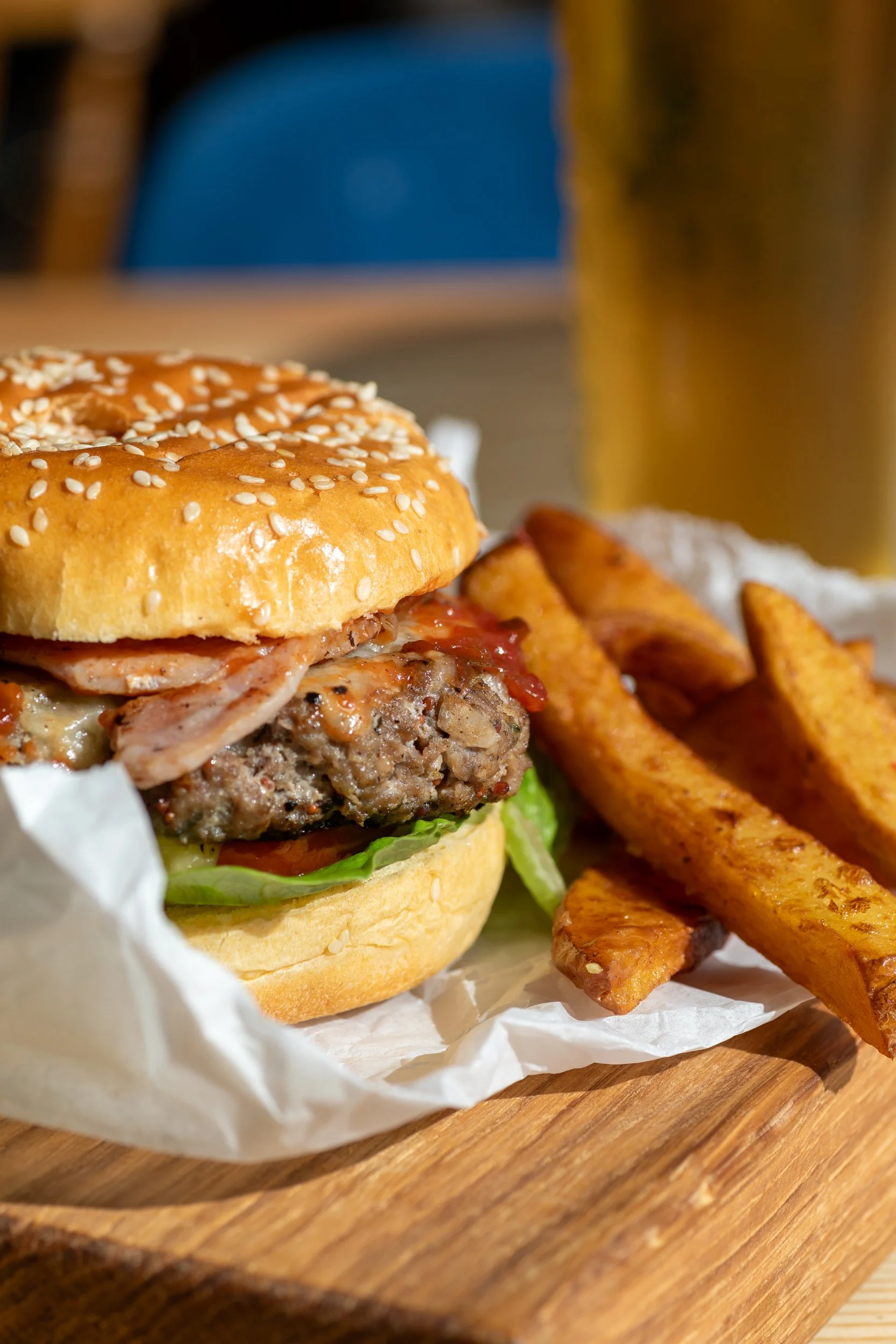 Cheeseburger and chips with ice cold lager at The Folly Wine Bar in Petersfield, Hampshire. Food photography by Sequoia Studios.