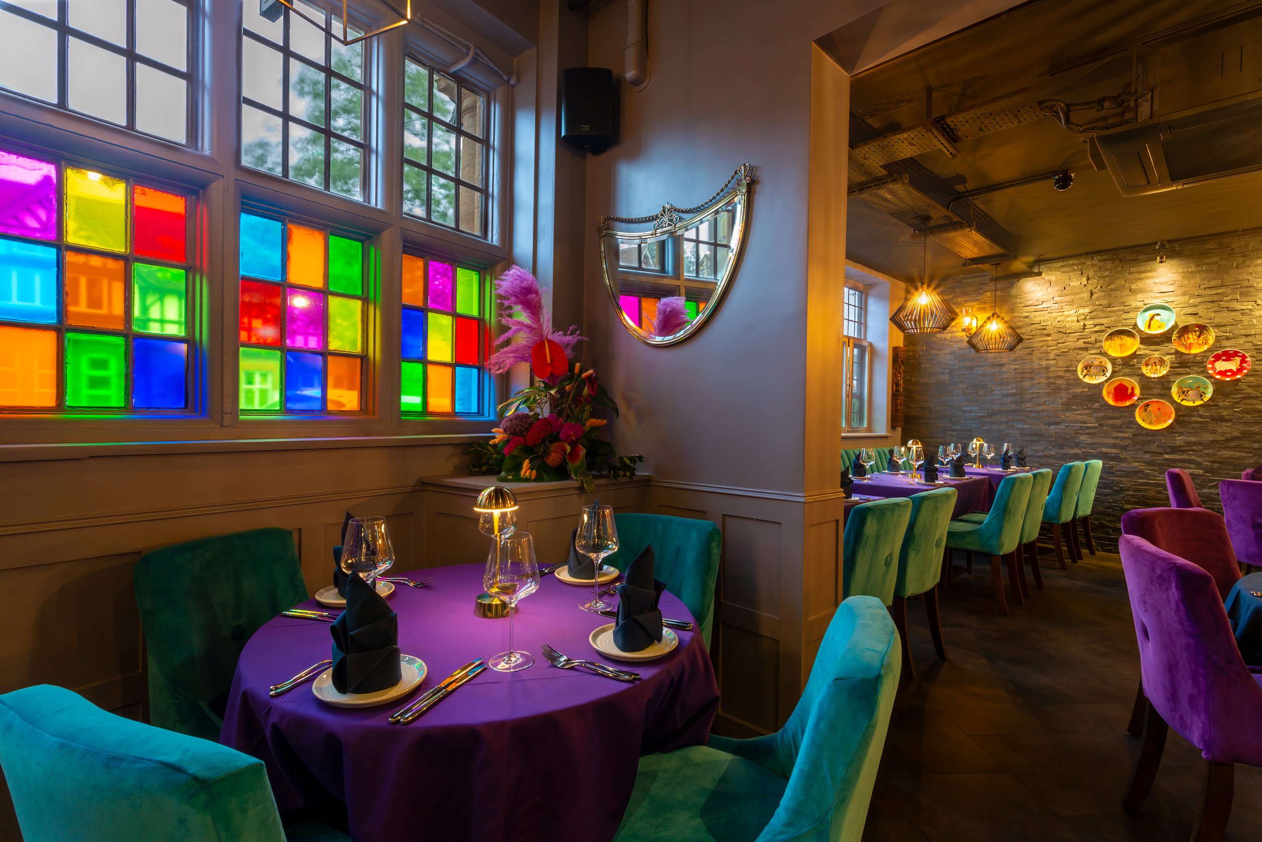 Tight crop of table set for dinner under colourful windows – The Dilli, Haslemere – Restaurant Photography by Sequoia Studios