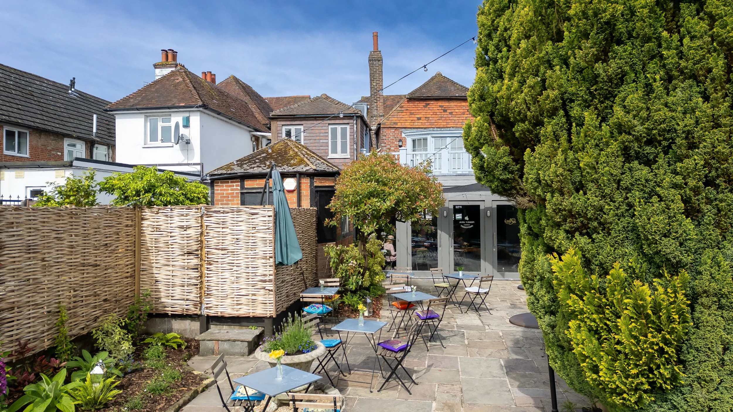 Slightly elevated drone shot of exterior enclosed courtyard – The Lion's Den Midhurst – Hospitality Venue Photography by Sequoia Studios