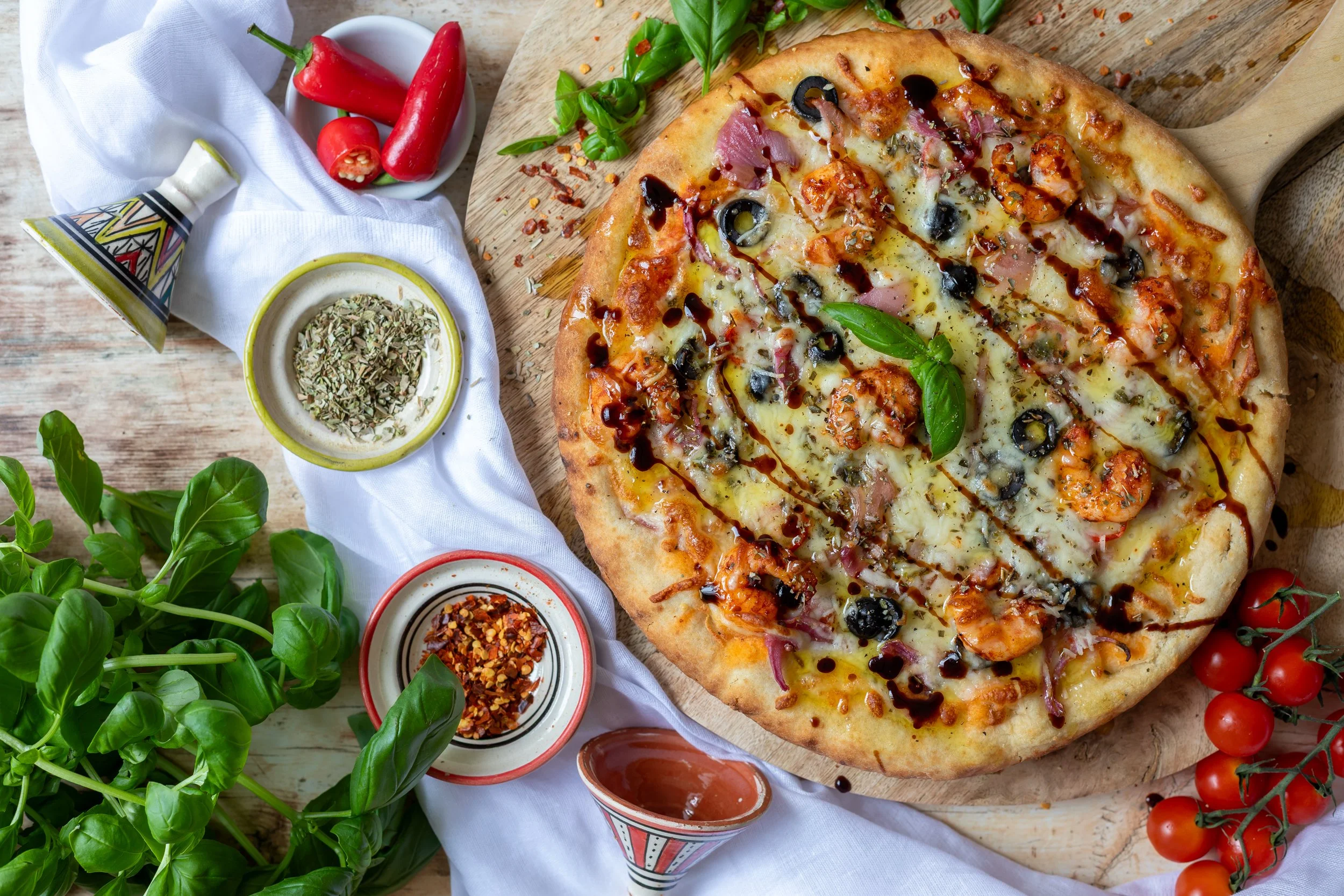 Fresh seafood pizza shot from above with herbs and cherry tomatoes