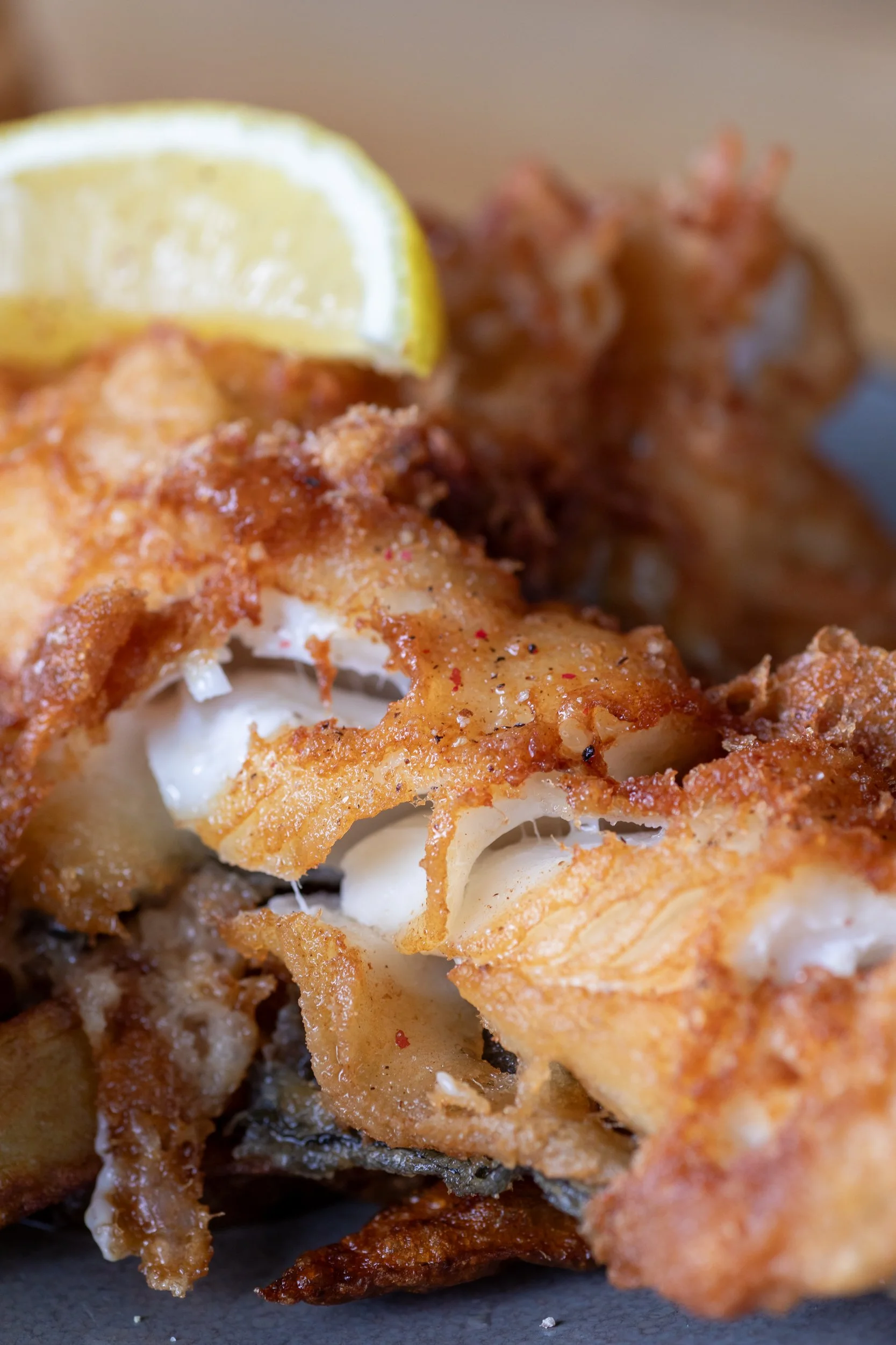 Close up of battered fish at The Folly Wine Bar in Petersfield, Hampshire. Food photography by Sequoia Studios.