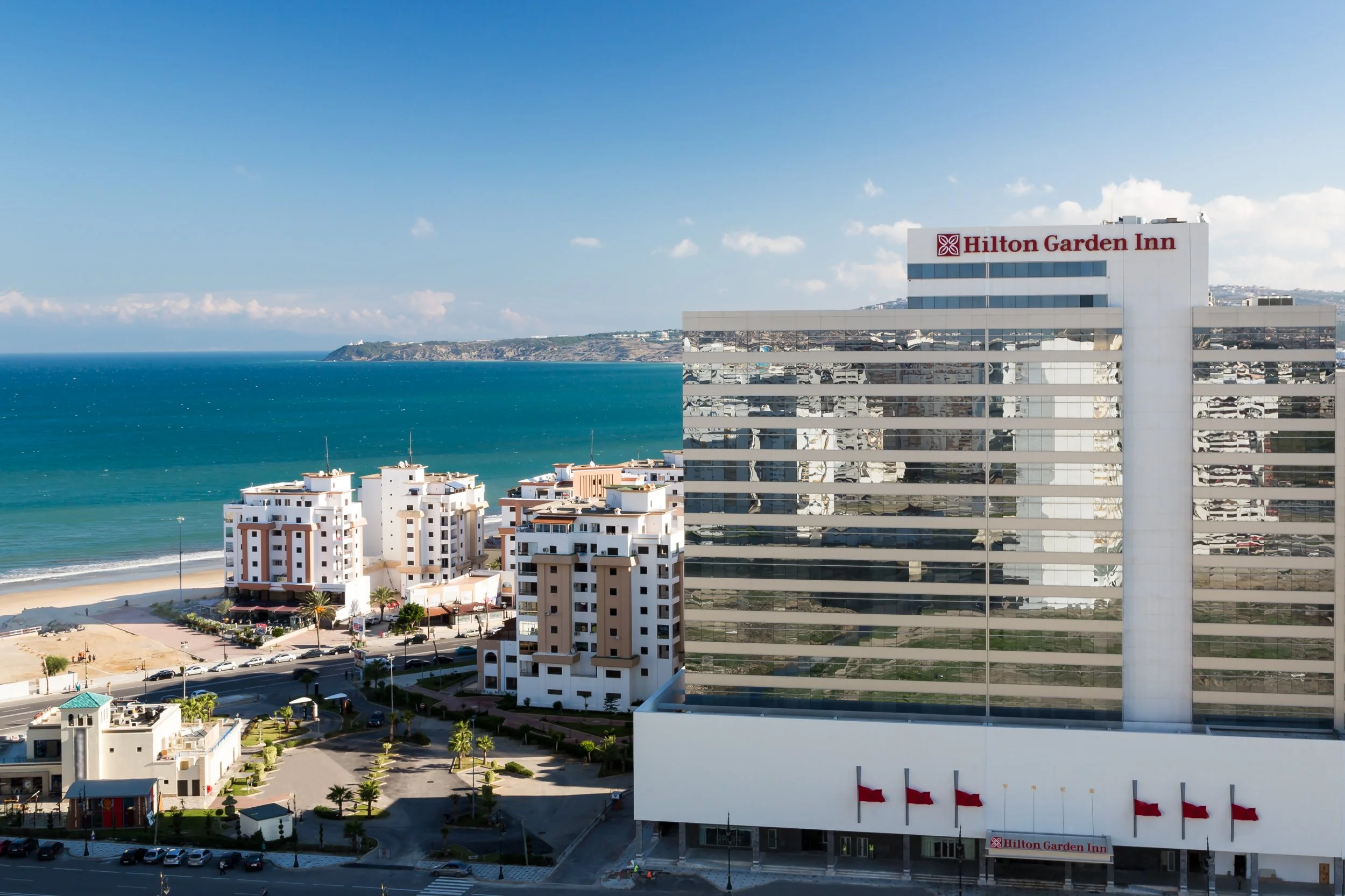 Daytime exterior of Hilton Garden Inn in Tangier, Morocco with attractive ocean view in background
