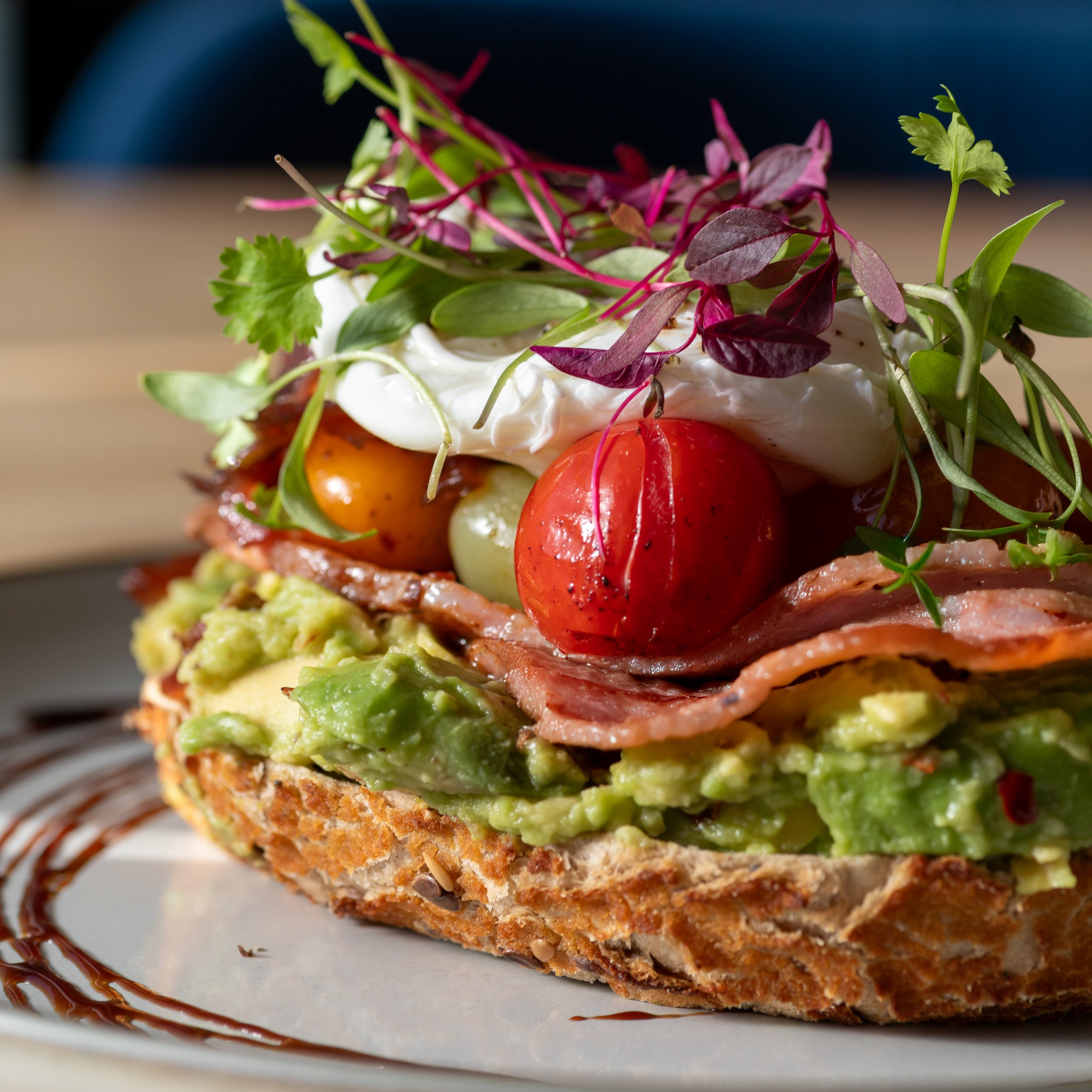 Smashed avocado on sourdough with bacon at The Folly Wine Bar in Petersfield, Hampshire. Food photography by Sequoia Studios.