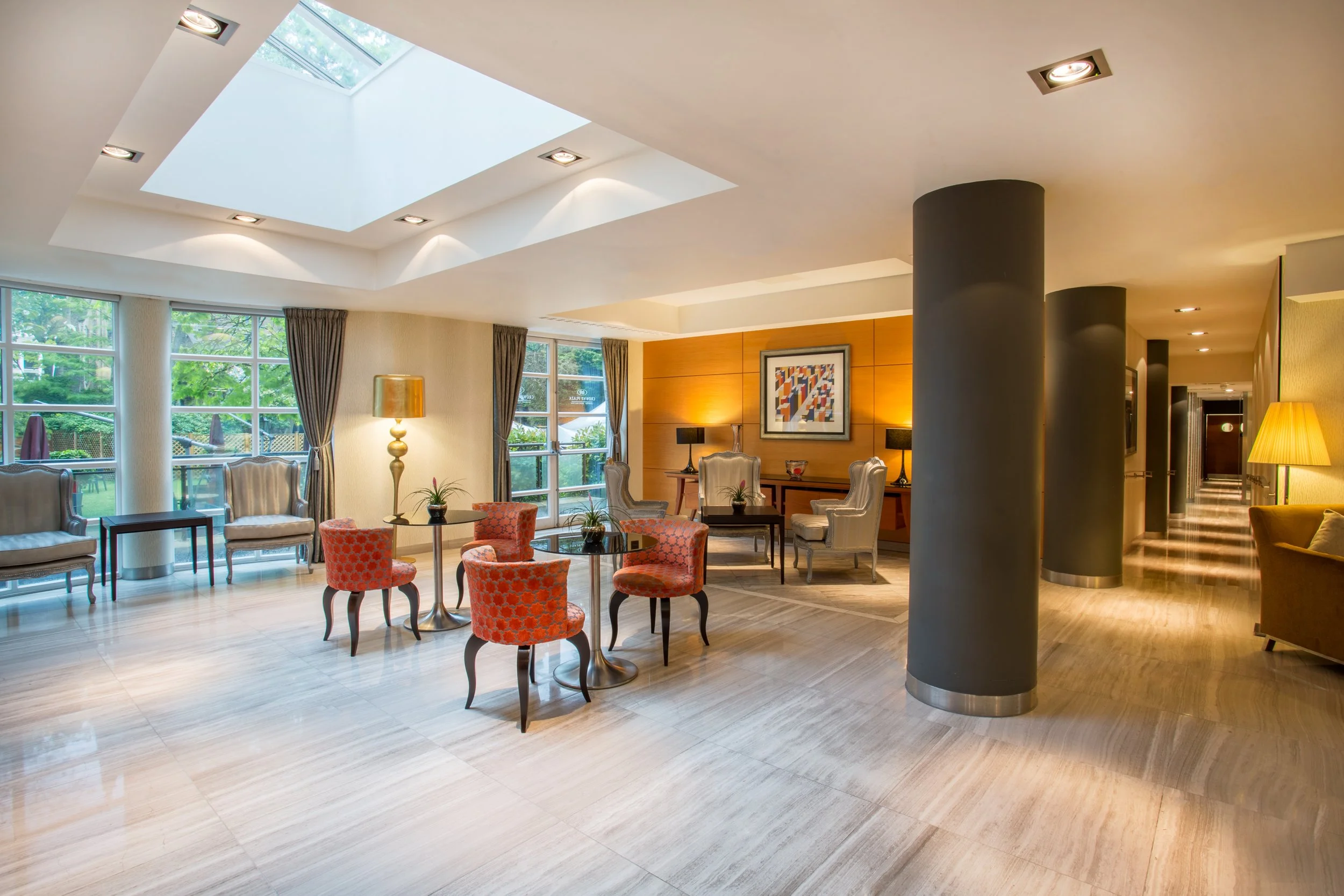 Refined lobby seating with garden view at Crowne Plaza hotel in Kensington, London
