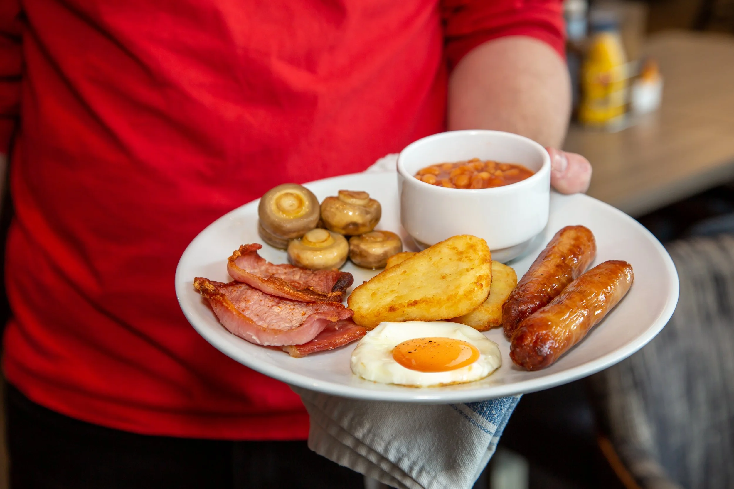 Irish breakfast served by hotel waiter