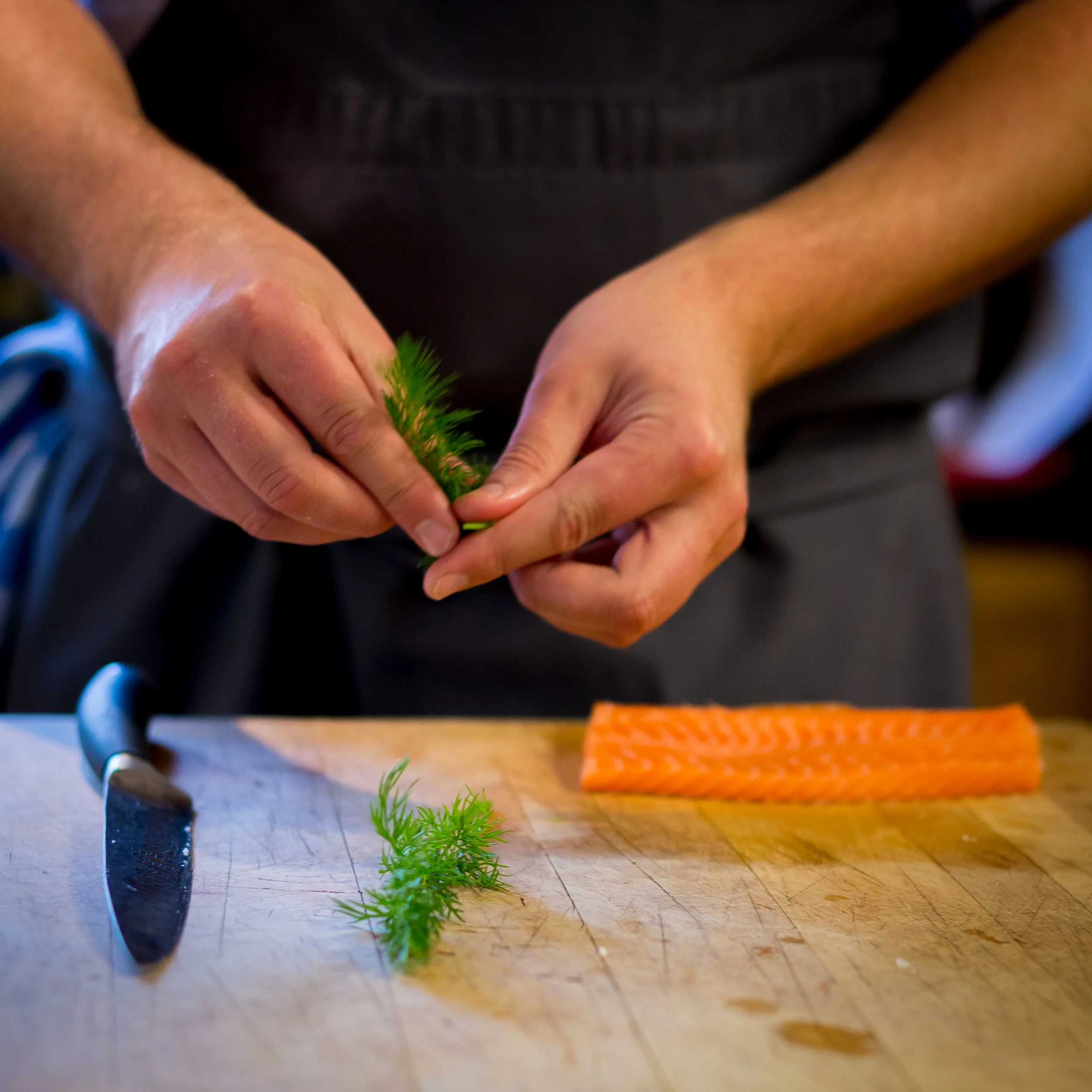 chef-preparing-salmon-le-manoir-aux-qait-seasons.jpg