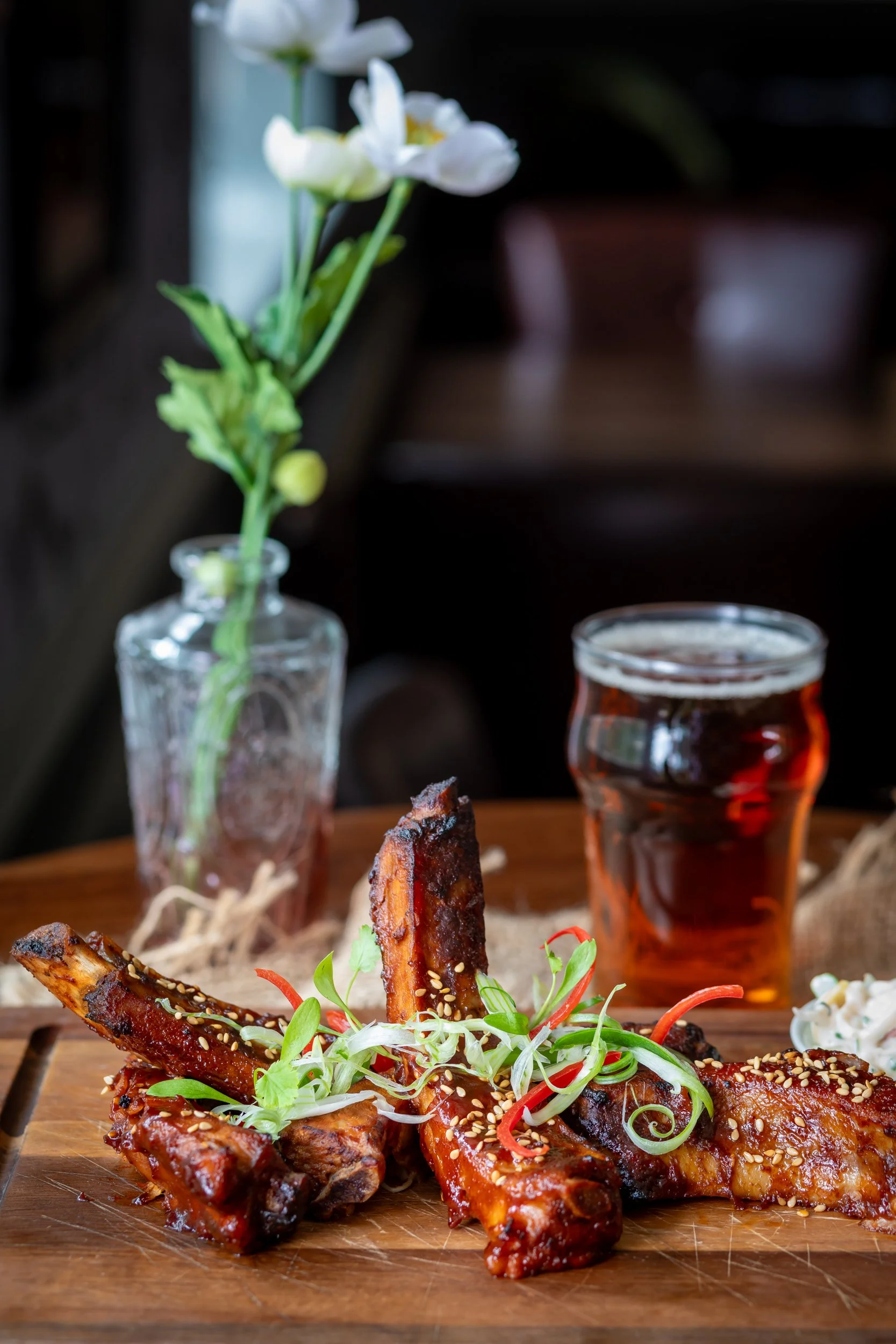 Portrait photo of Korean-style pork ribs paired with local ale at The Wheatsheaf Inn Grayswood, Surrey – Food Photography by Sequoia Studios