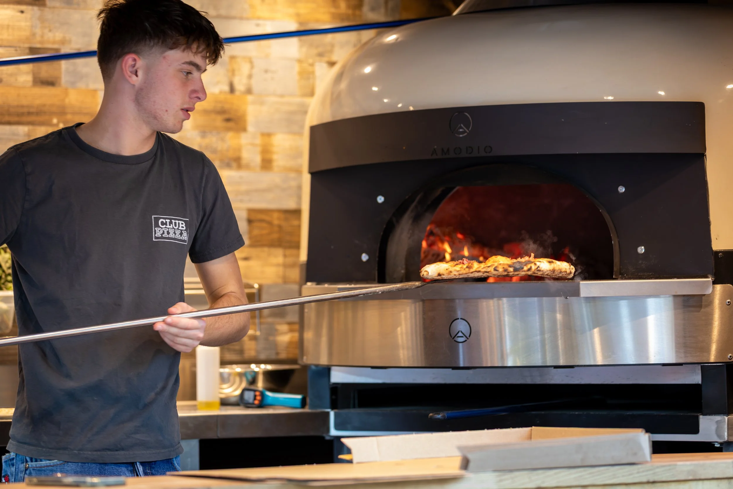 Pizza fresh out of the wood-fired oven from the Club Pizza van at The Crossways Inn, Churt, Surrey. Hospitality & food photography by Sequoia Studios