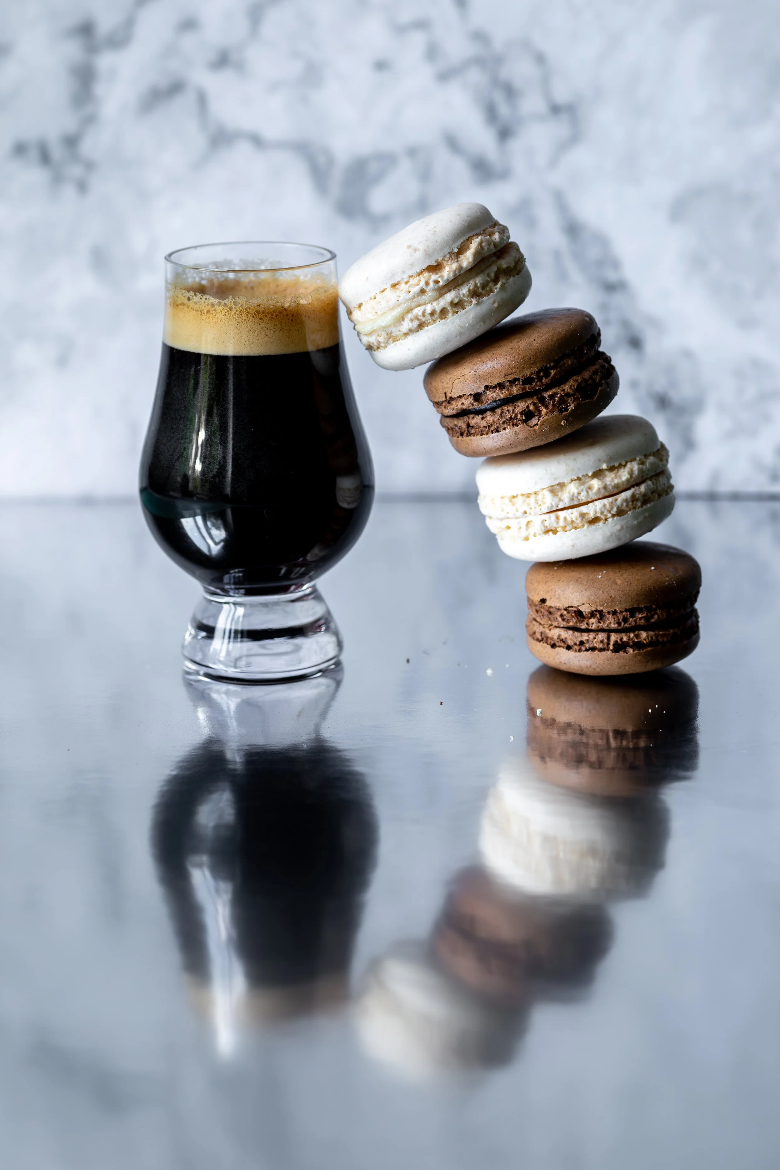 macarons-stacked-against-glass-of-espresso-coffee.jpg