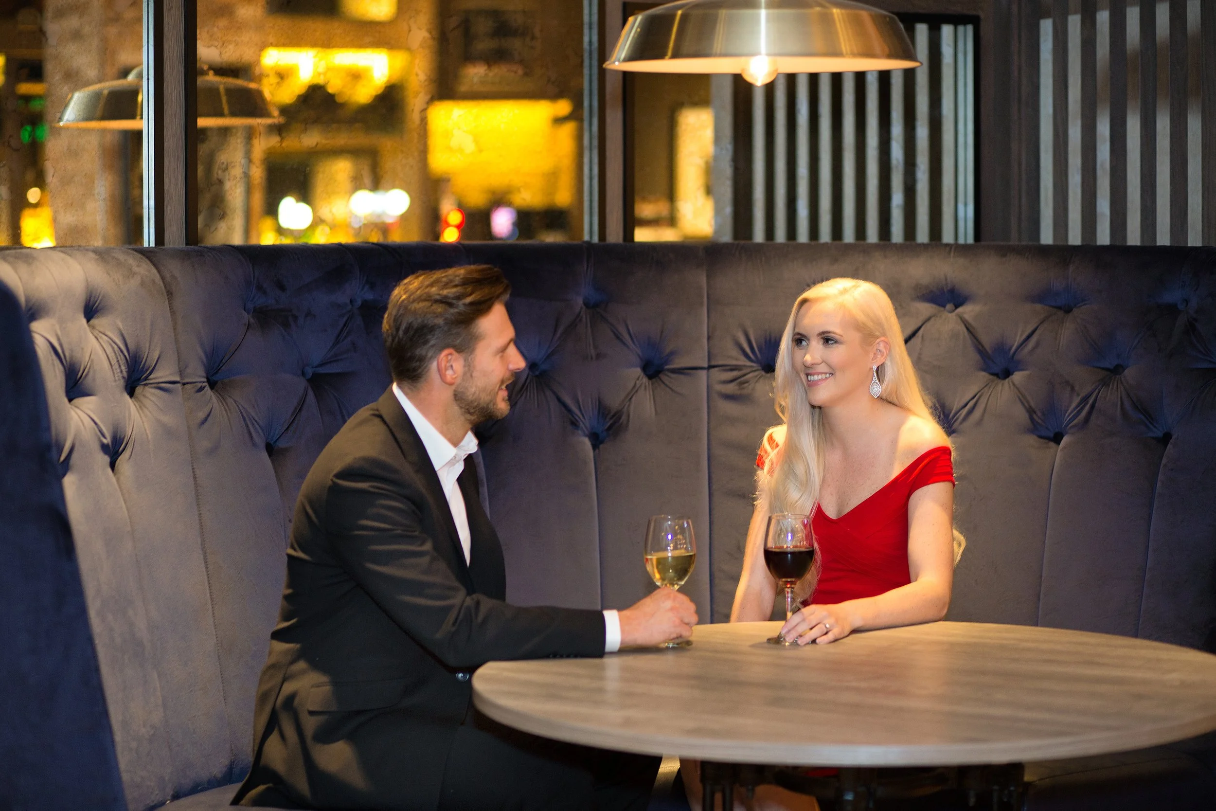 A couple seated at a table enjoying a drink at the hotel bar at Doubletree Hilton in Glasgow
