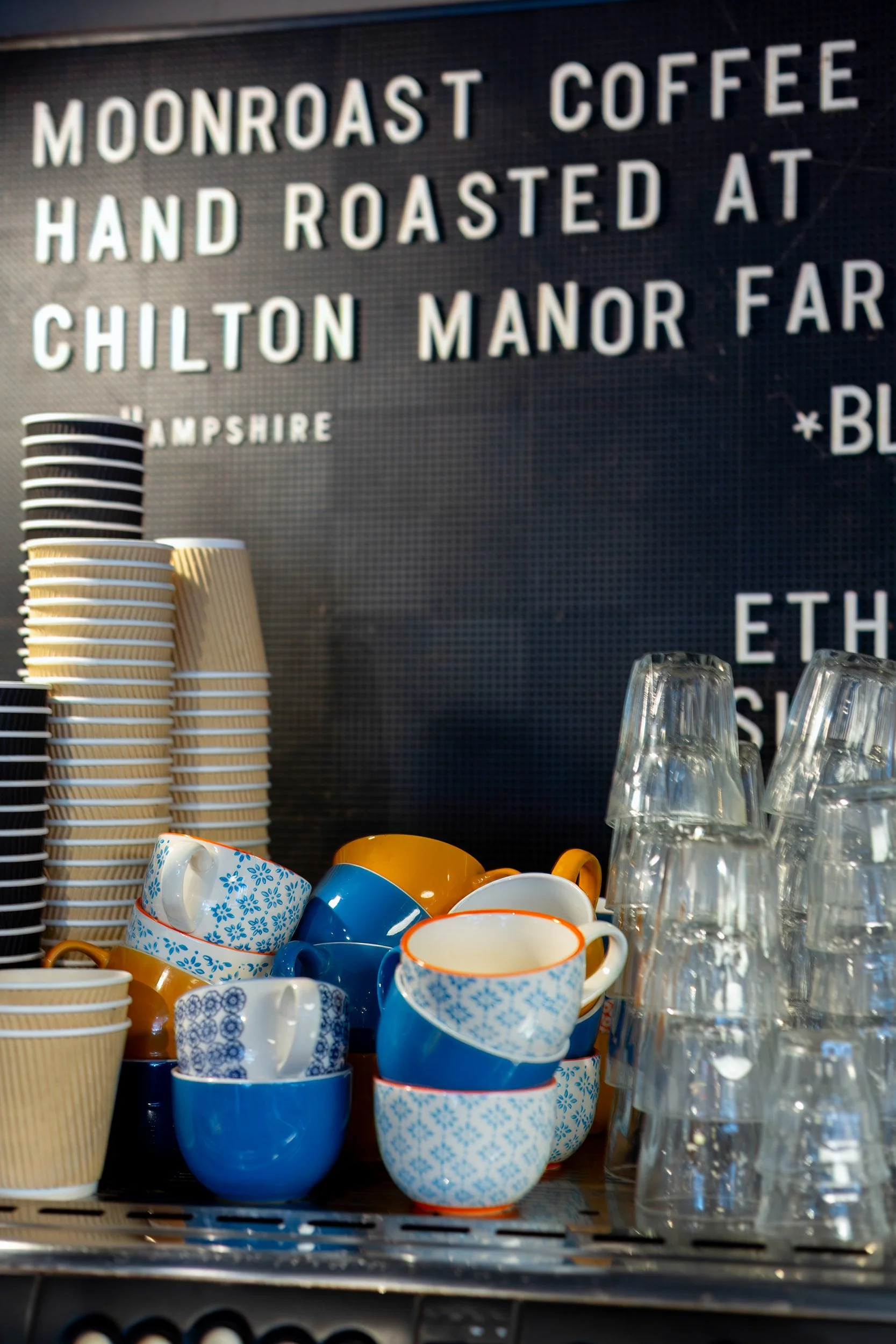 stack-of-coffee-machine-cups-lions-den-cafe-haslemere.jpg