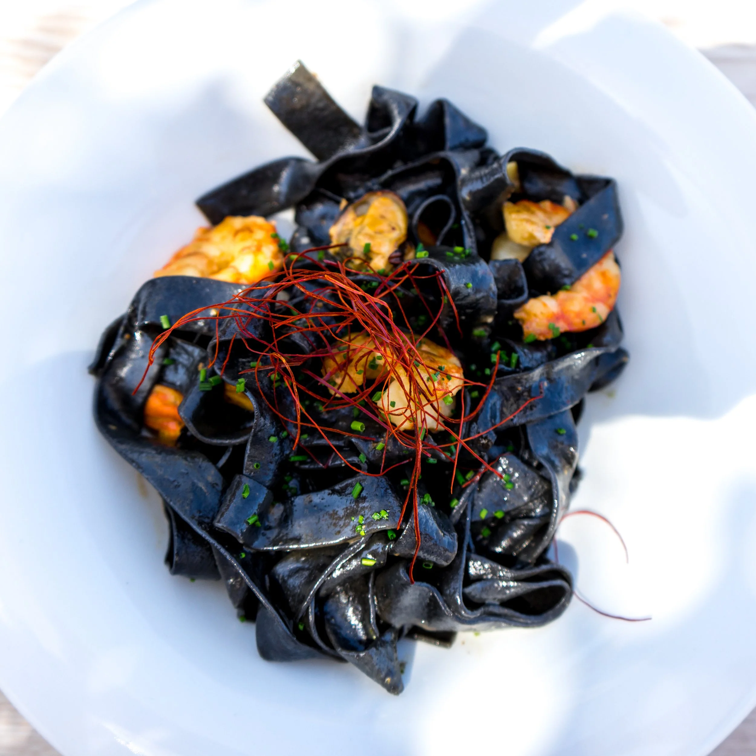 Squid ink papperdelle with prawns