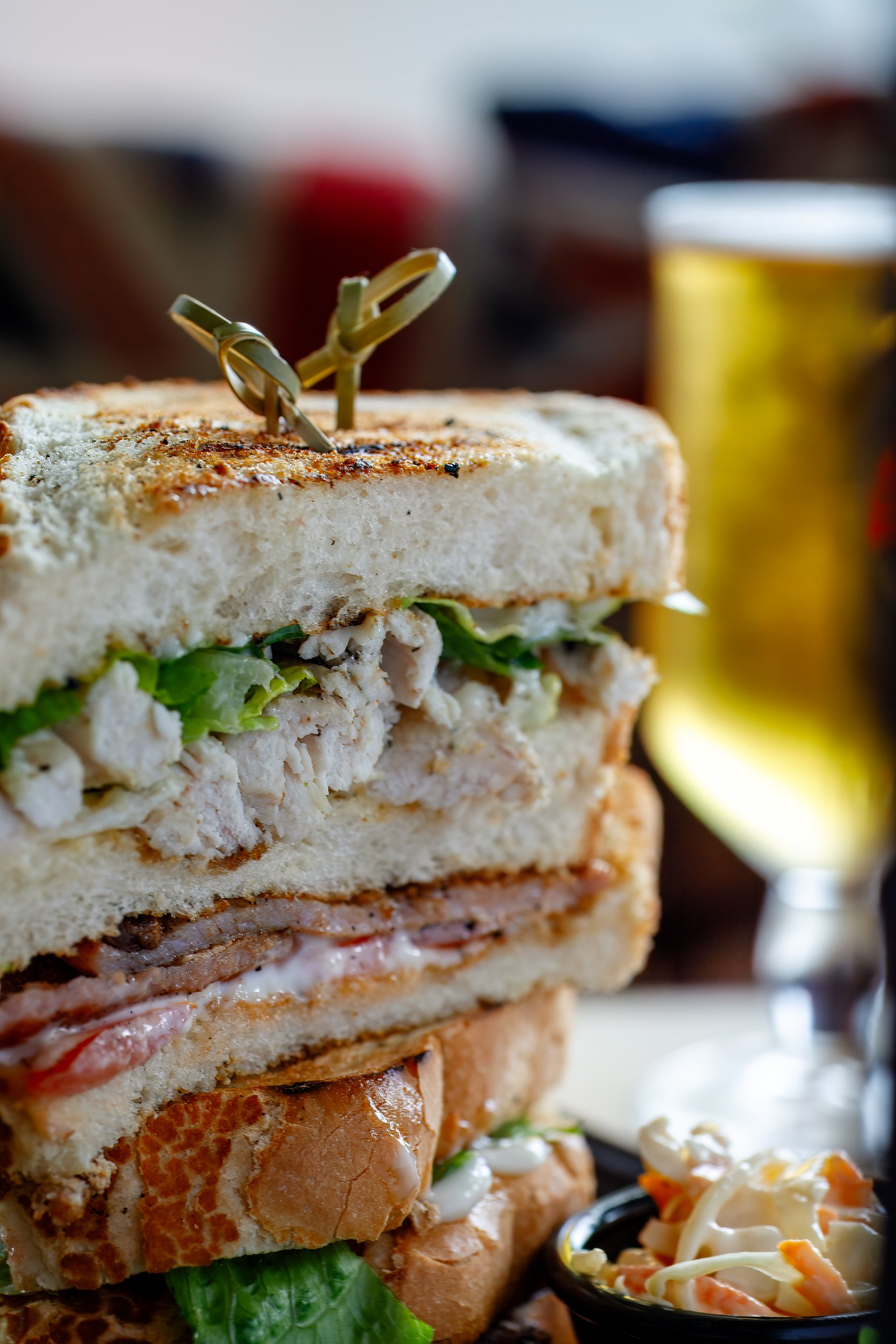 Close up of classic club sandwich with beer at The Folly Wine Bar in Petersfield, Hampshire. Food photography by Sequoia Studios.