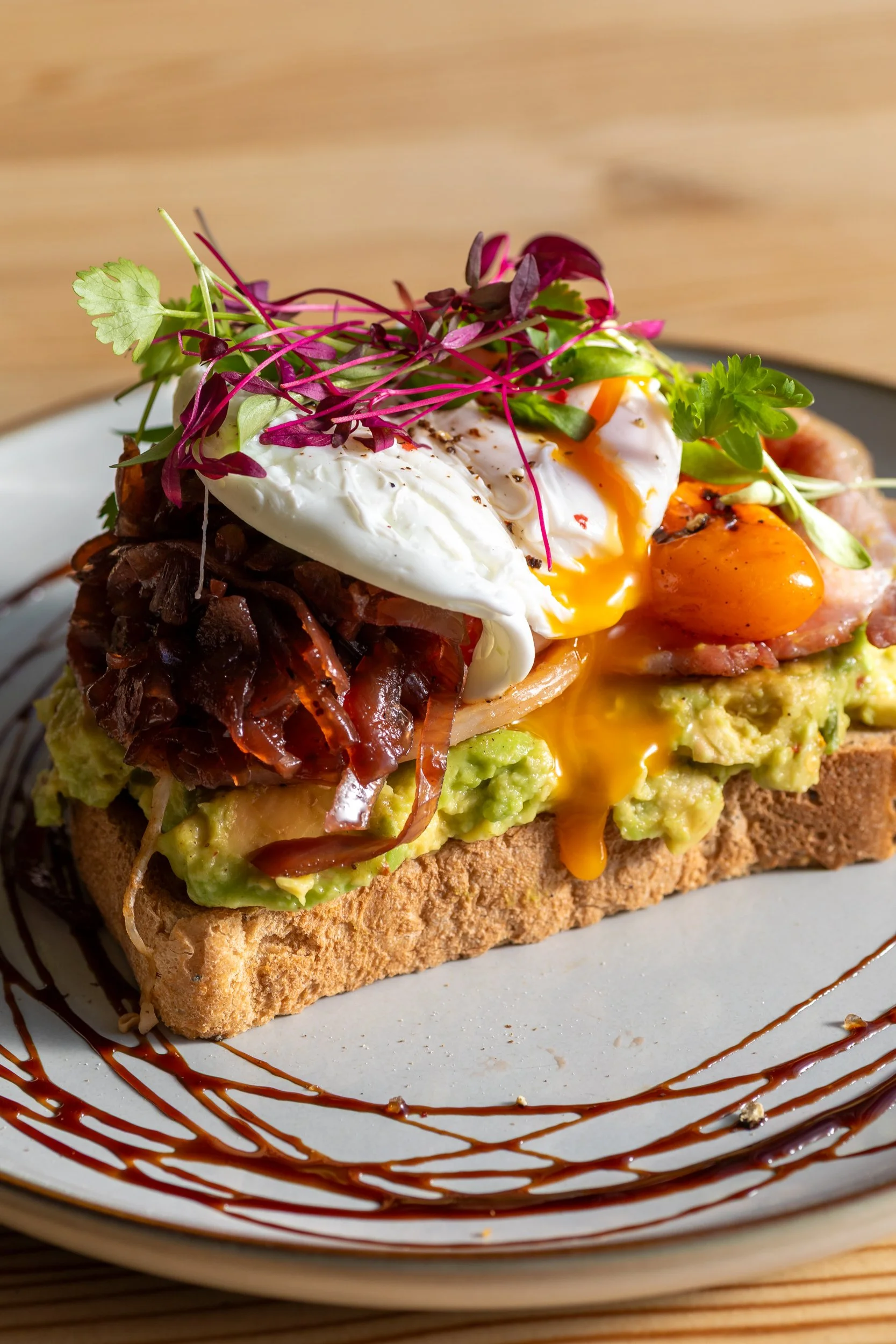Smashed avocado on sourdough with runny poached egg at The Folly Wine Bar in Petersfield, Hampshire. Food photography by Sequoia Studios.