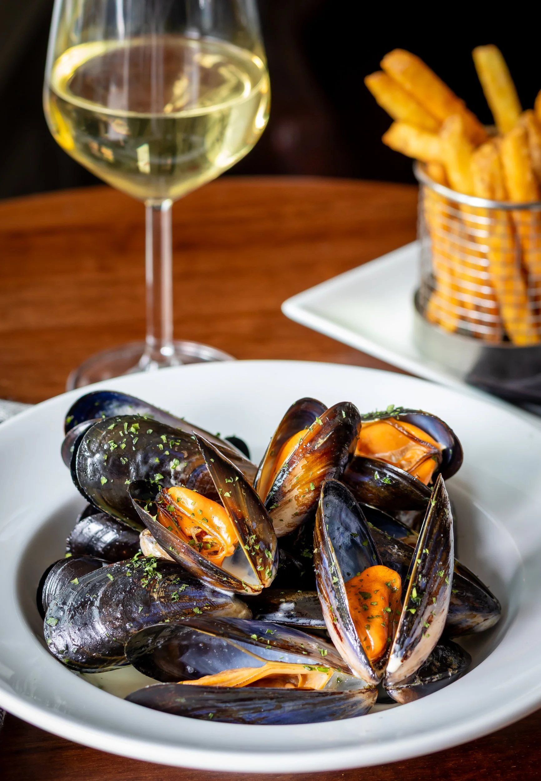 Portrait photo of Moules Mariniere with frites, paired with white wine at The Wheatsheaf Inn Grayswood, Surrey – Food Photography by Sequoia Studios