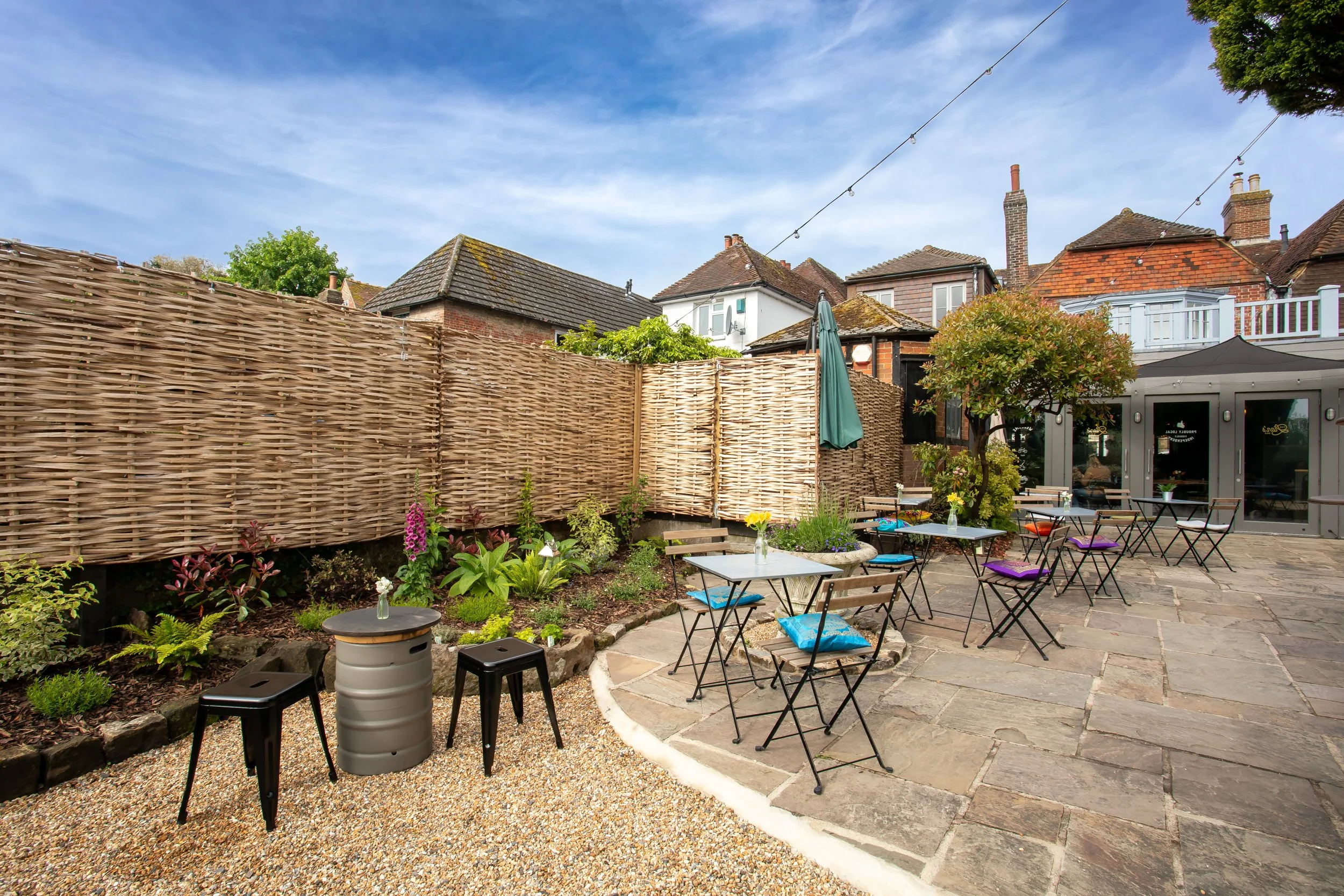 Daytime exterior of the courtyard at The Lion's Den in Midhurst, West Sussex