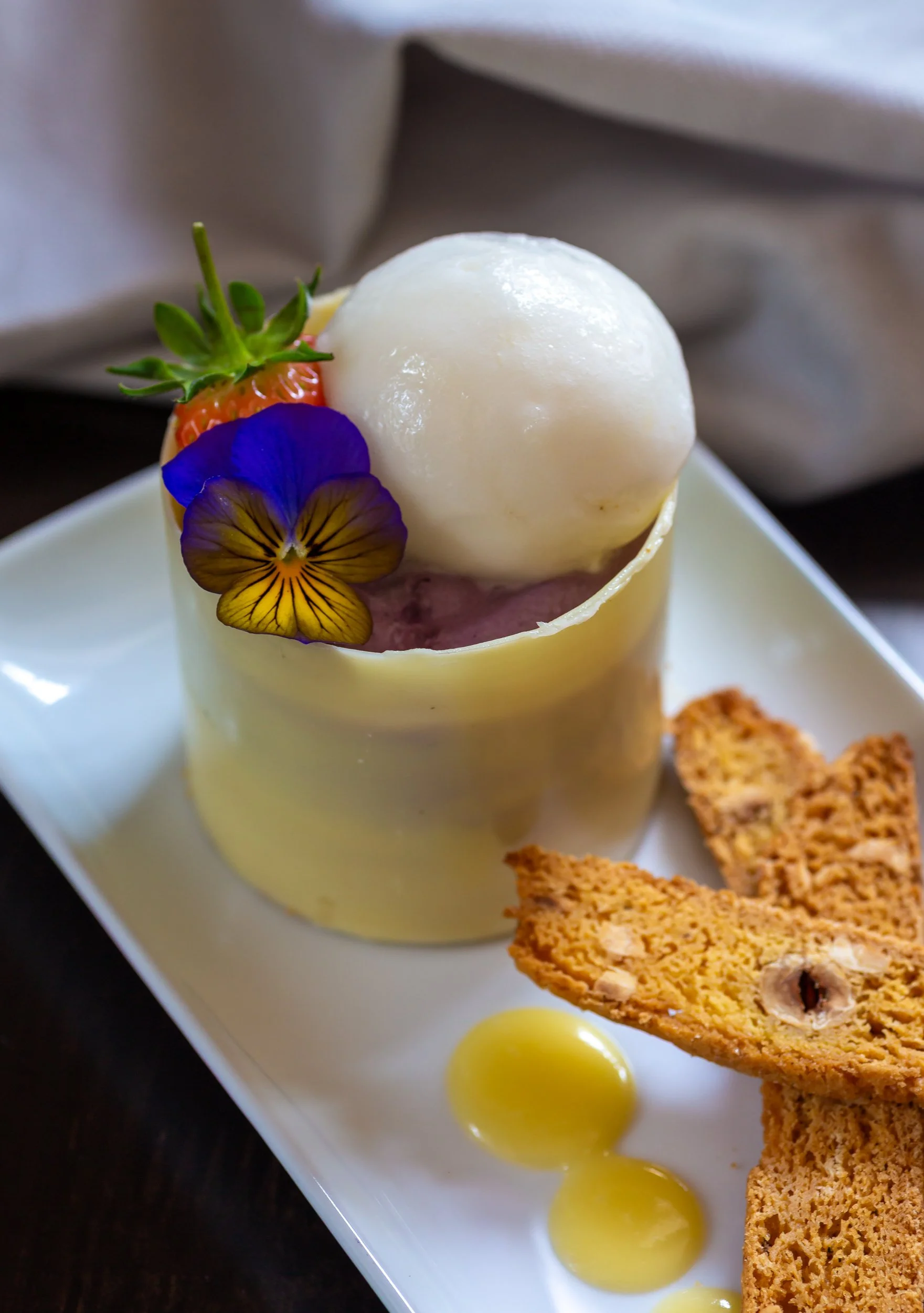 White chocolate and blueberry cheesecake dessert with light raspberry sorbet and biscotti at The Wheatsheaf Inn Grayswood, Surrey – Pub Food Photography by Sequoia Studios