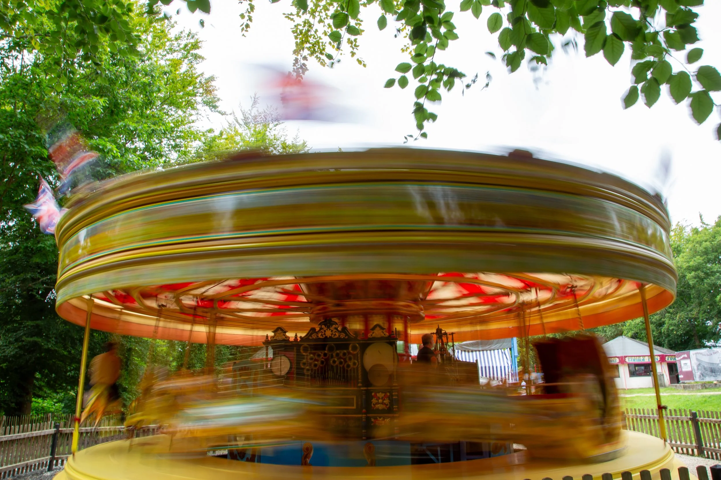 Steam-powered merry-go-round ride in motion – Hollycombe Steam In The Country – Event Photography by Sequoia Studios