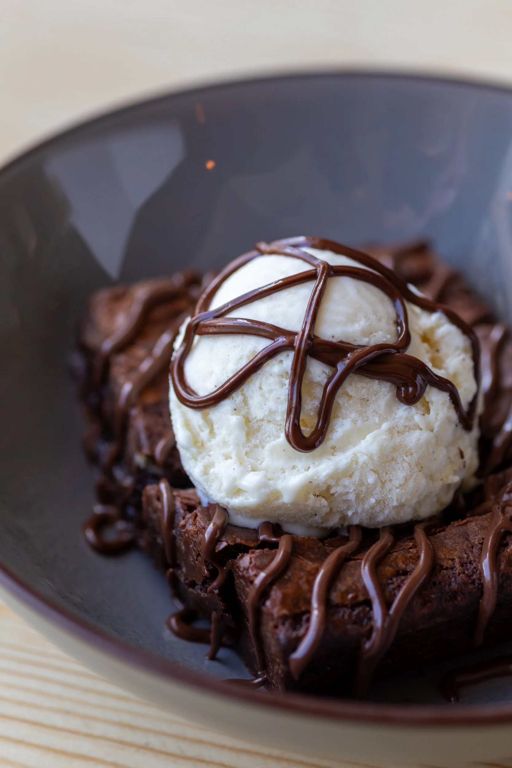 Warm chocolate brownie, chocolate sauce and vanilla ice cream at The Folly Wine Bar in Petersfield, Hampshire. Food photography by Sequoia Studios.