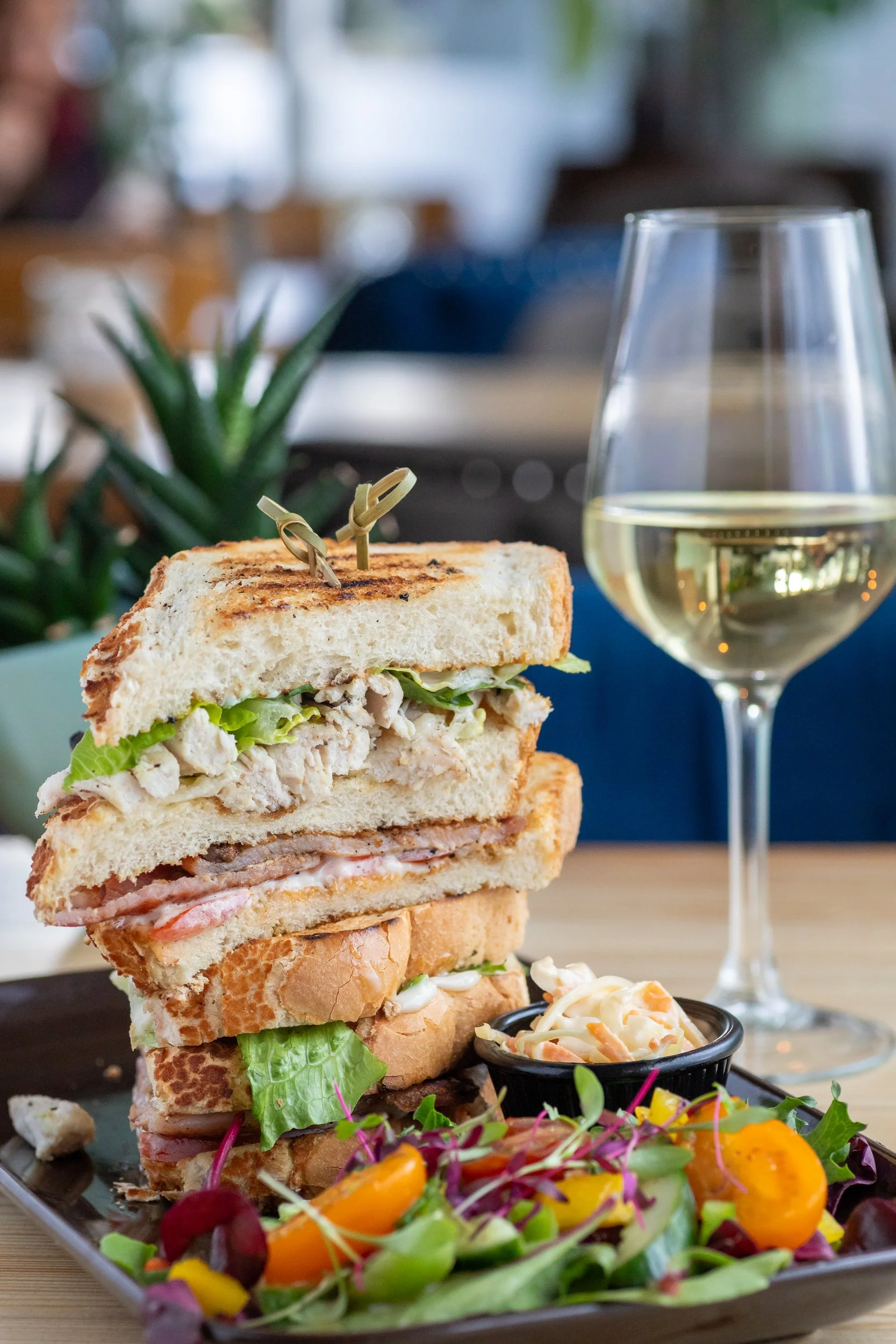 Classic club sandwich with chilled white wine at The Folly Wine Bar in Petersfield, Hampshire. Food photography by Sequoia Studios.