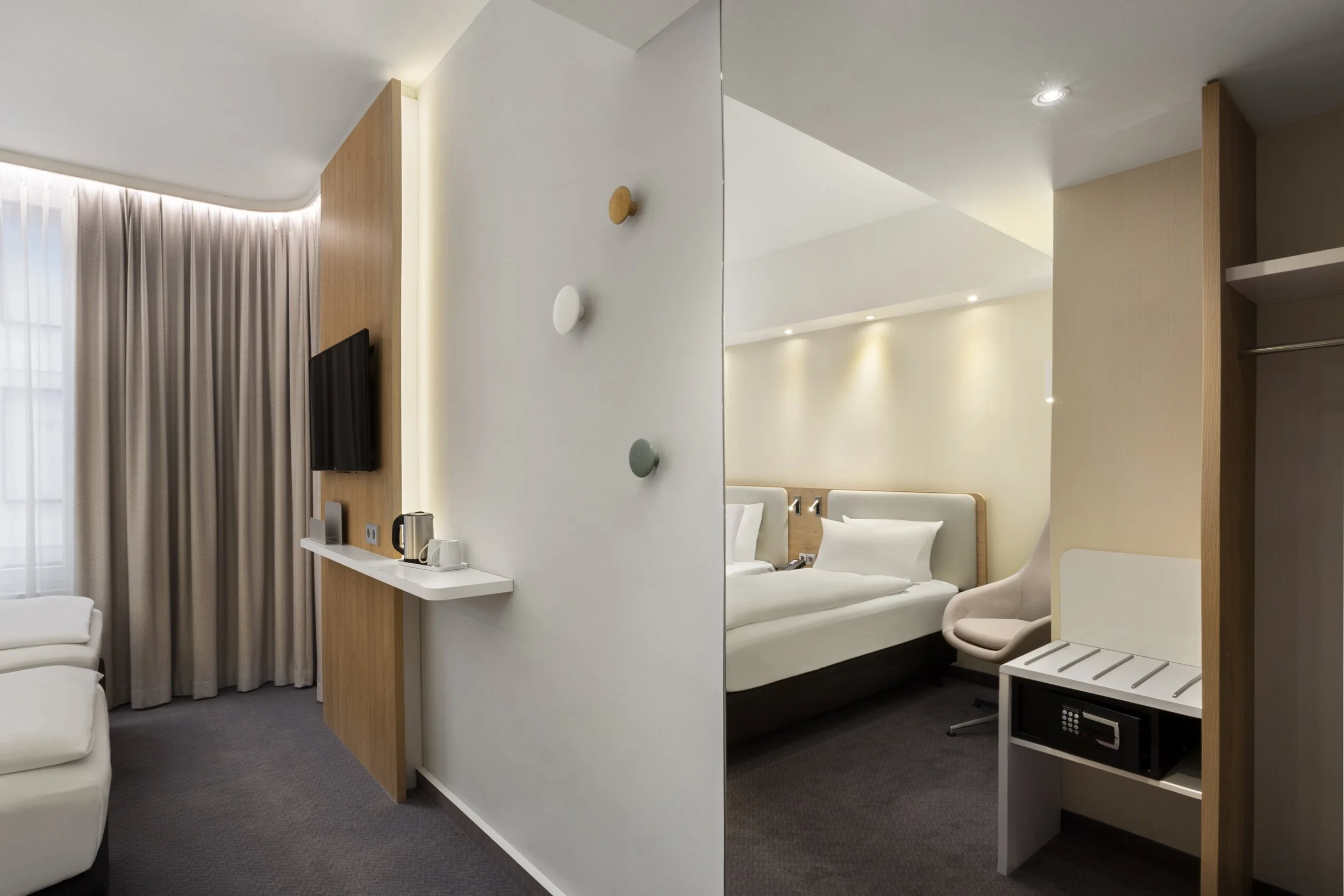 Guest twin room shot through mirror – Holiday Inn Express Munich – Hotel Photography by Sequoia Studios