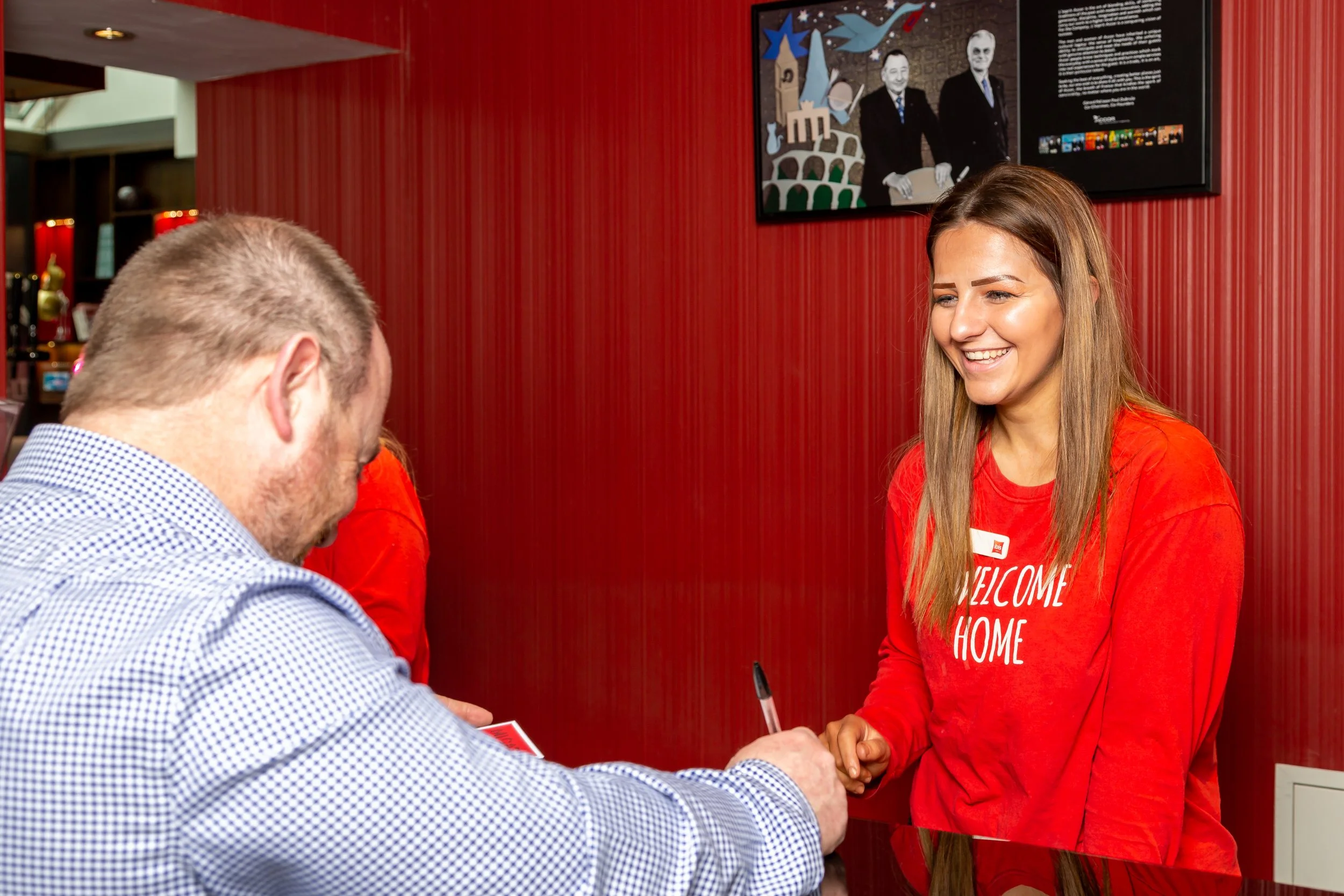 smiling-female-receptionist-check-in-guest-ibis-hotel-belfast.jpg